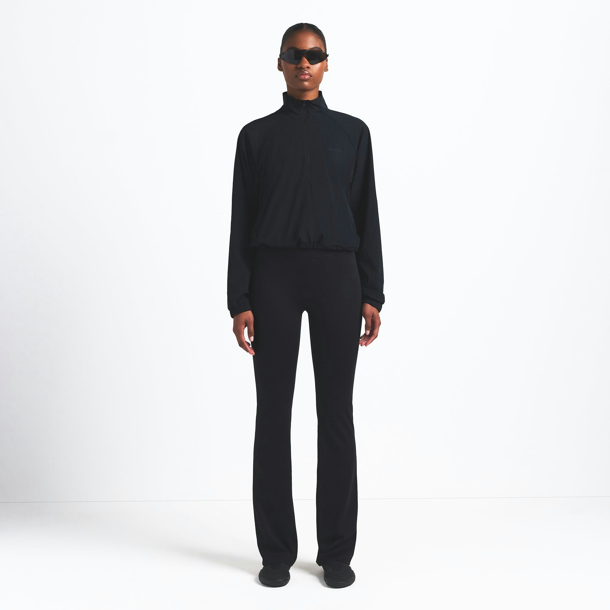 NikeSKIMS WOVEN NYLON HALF ZIP JACKET | OBSIDIAN ON A MODEL FRONT VIEW @ | FOCUS: 0.0, 1.0, 0.9