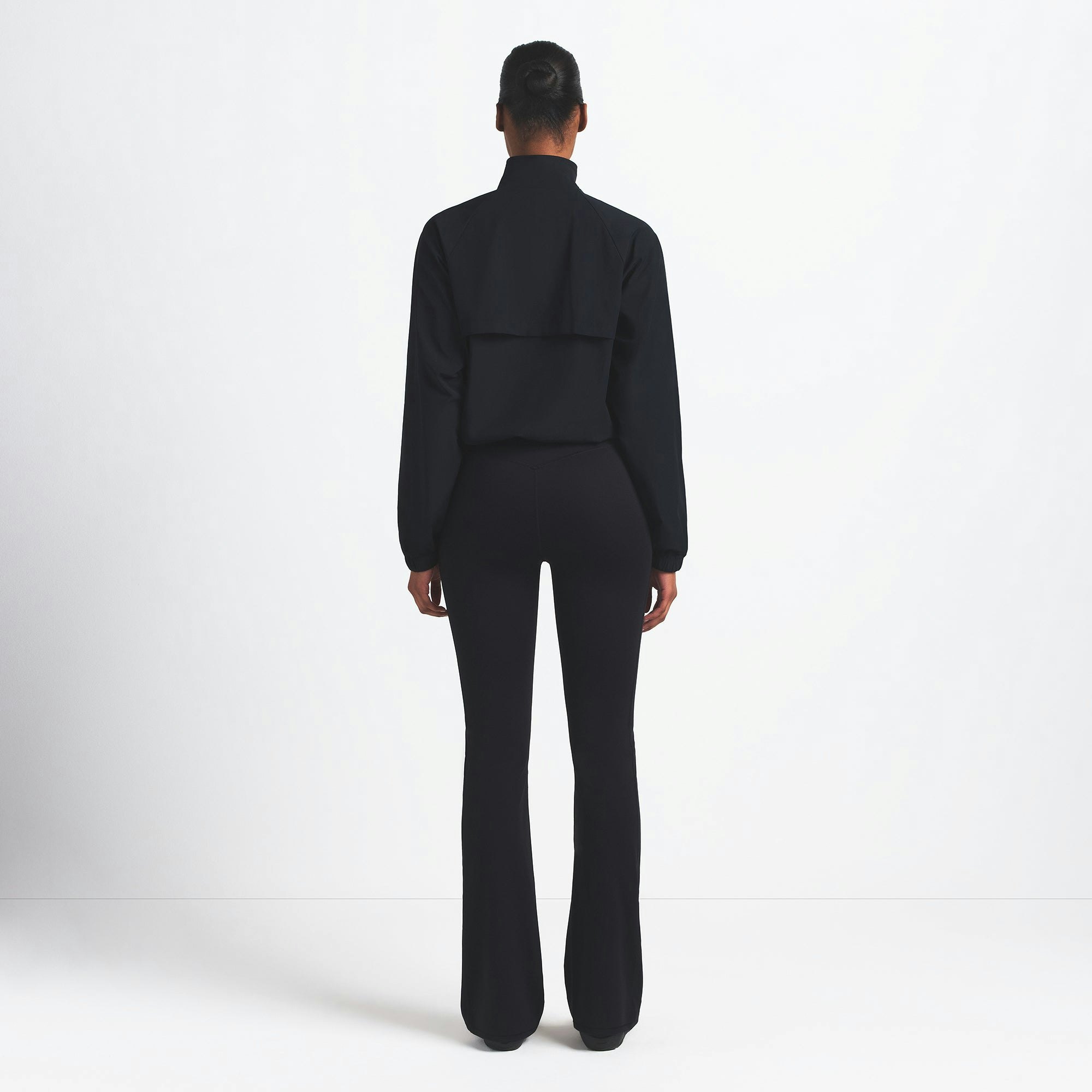 NikeSKIMS WOVEN NYLON HALF ZIP JACKET | OBSIDIAN ON A MODEL BACK VIEW @ | FOCUS: 0.0, 1.0, 0.9