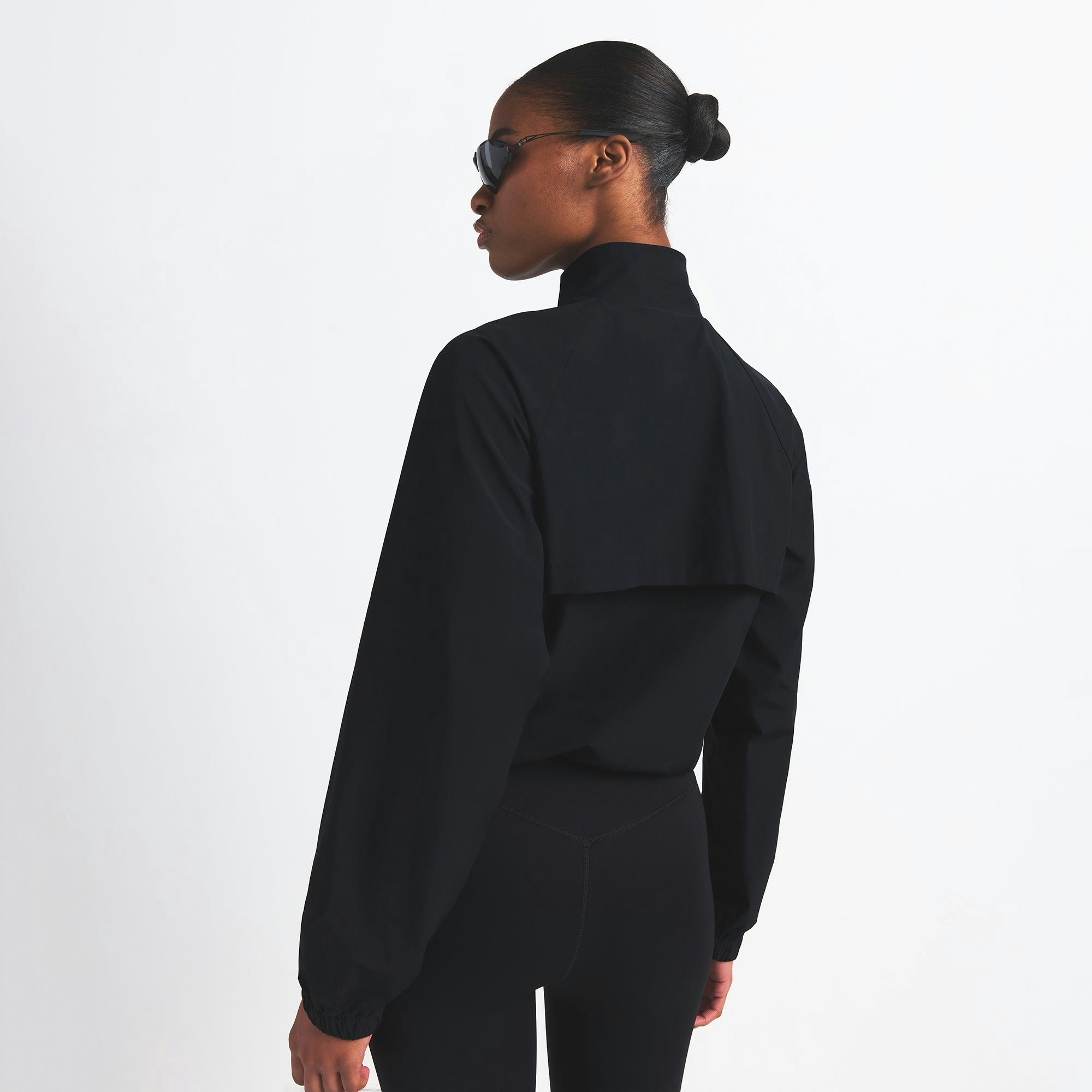 NikeSKIMS WOVEN NYLON HALF ZIP JACKET | OBSIDIAN ON A MODEL BACK VIEW @ | FOCUS: 0.0, 1.0, 0.9