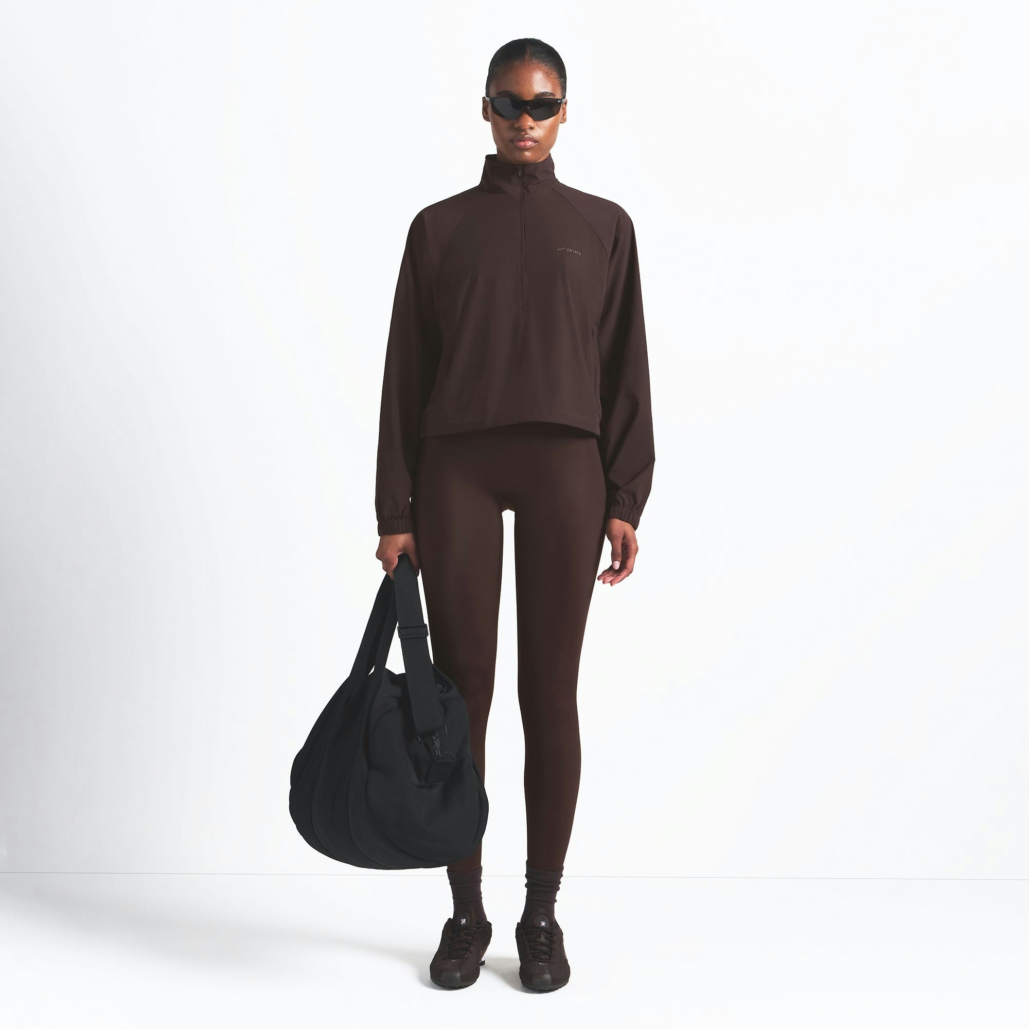 NikeSKIMS WOVEN NYLON HALF ZIP JACKET | PHOENIX ON A MODEL FRONT VIEW @ | FOCUS: 0.0, 1.0, 0.9