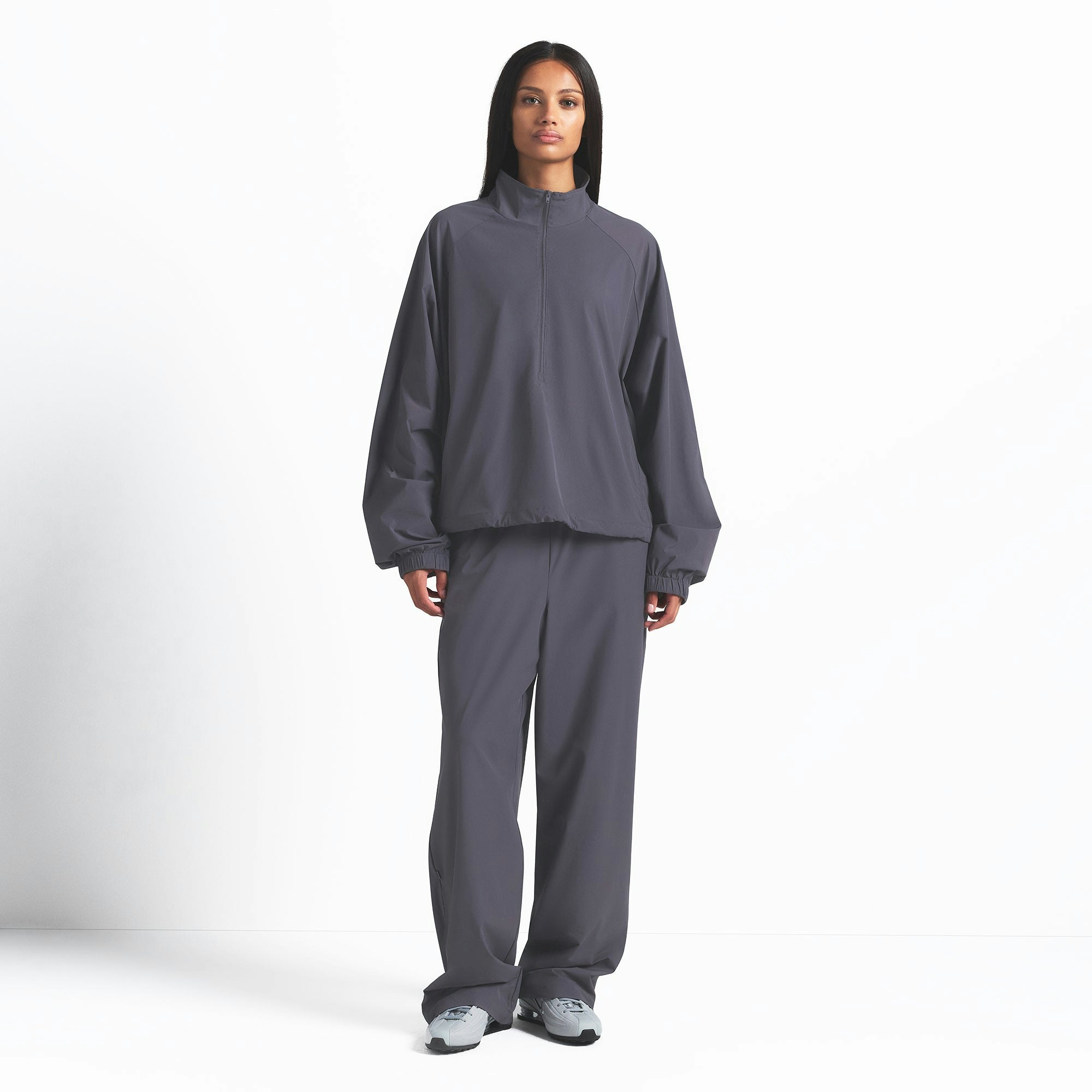 NikeSKIMS WOVEN NYLON HALF ZIP JACKET | RAVEN ON A MODEL FRONT VIEW @ | FOCUS: 0.0, 1.0, 0.9