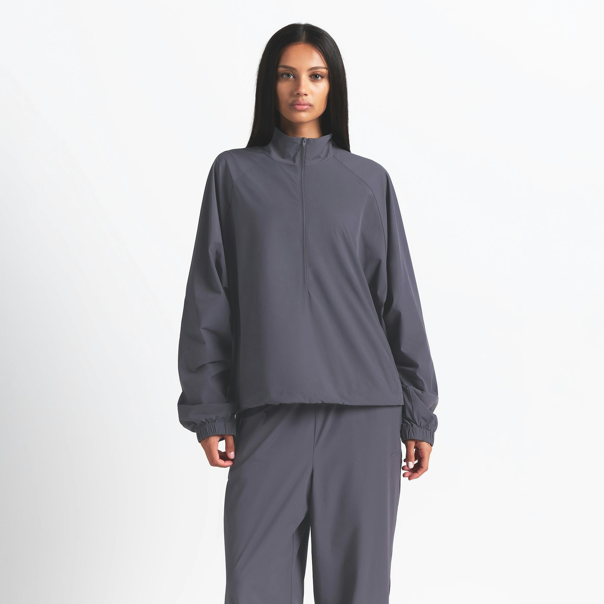 NikeSKIMS WOVEN NYLON HALF ZIP JACKET | RAVEN ON A MODEL FRONT VIEW @ | FOCUS: 0.0, 1.0, 0.9