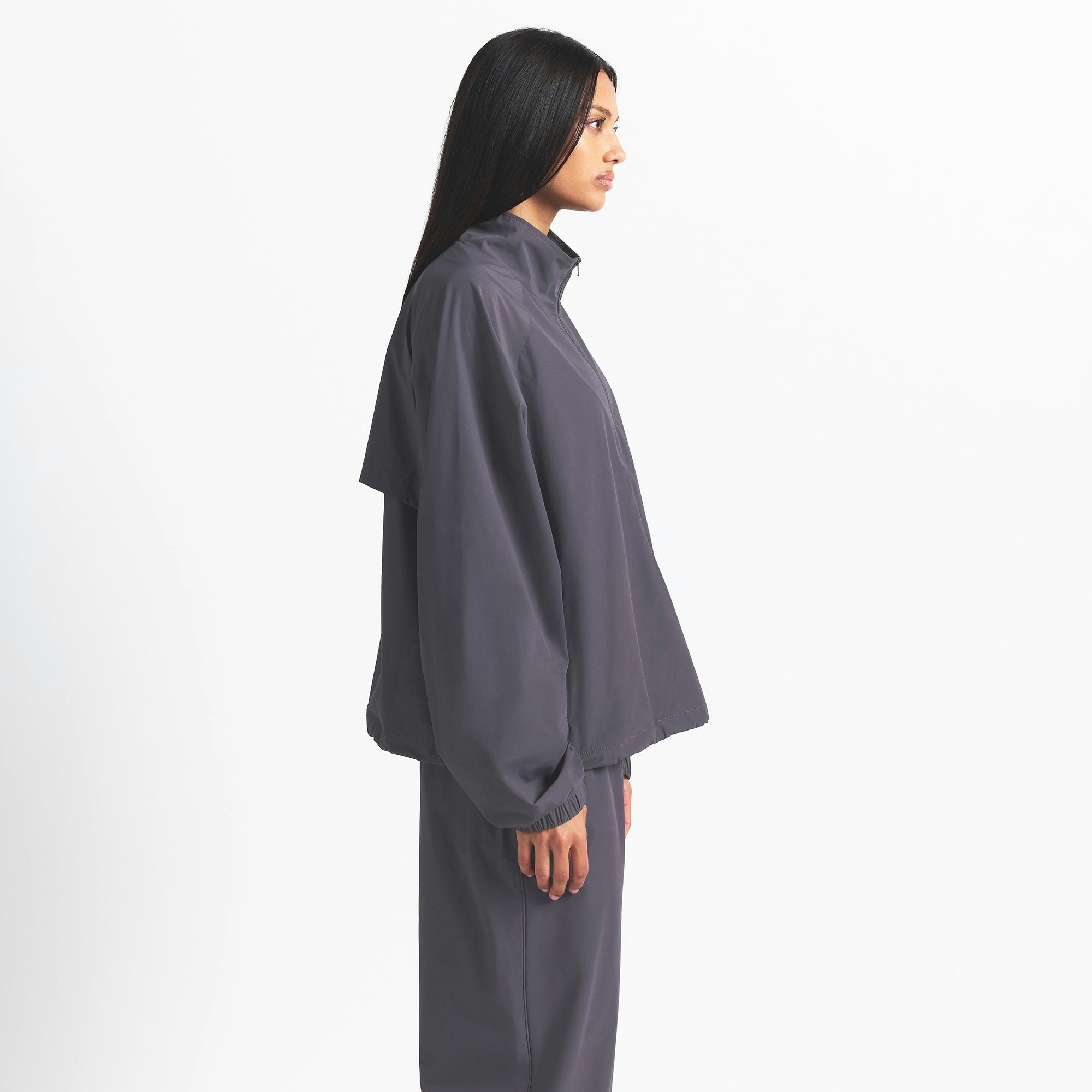 NikeSKIMS WOVEN NYLON HALF ZIP JACKET | RAVEN ON A MODEL SIDE VIEW @ | FOCUS: 0.0, 1.0, 0.9