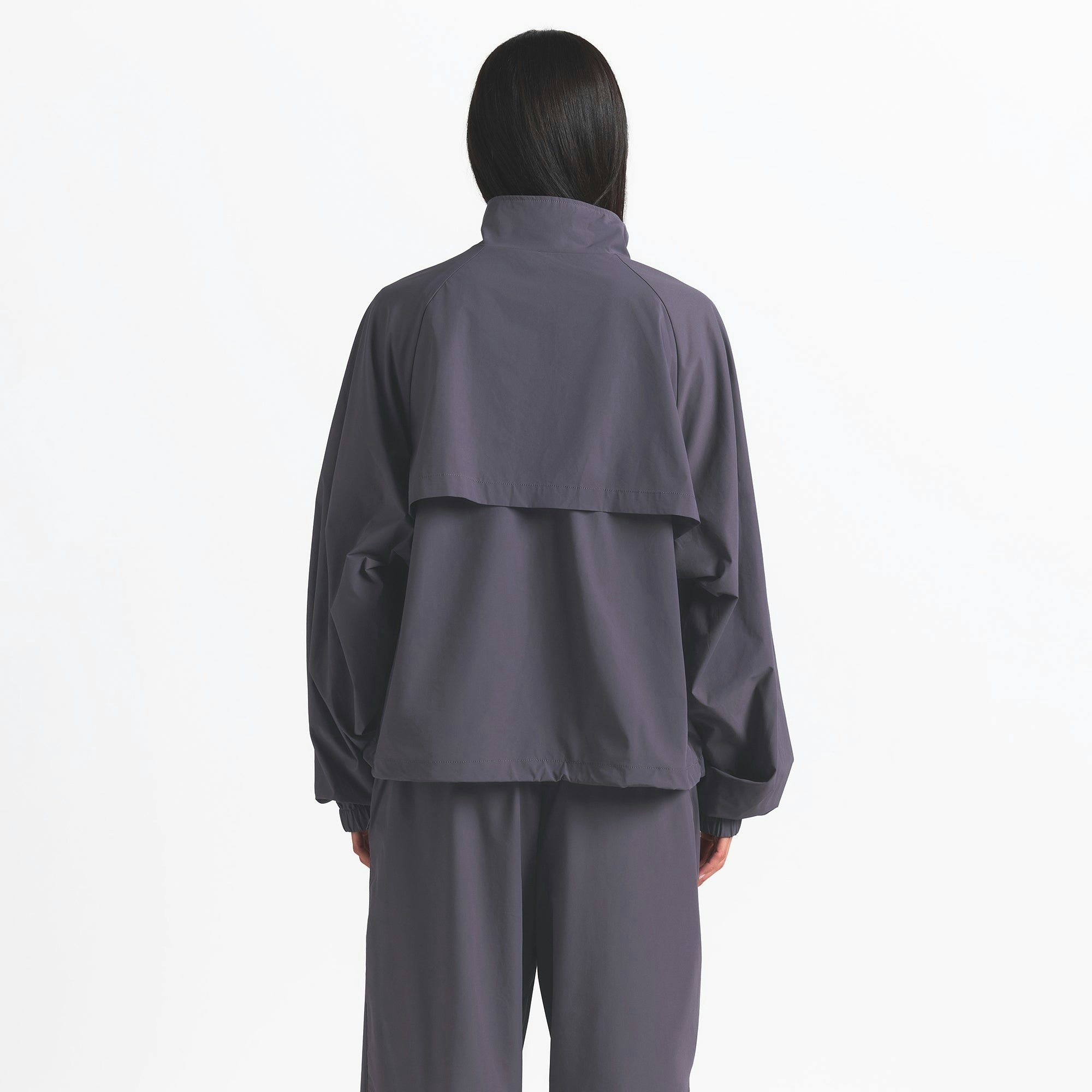 NikeSKIMS WOVEN NYLON HALF ZIP JACKET | RAVEN ON A MODEL BACK VIEW @ | FOCUS: 0.0, 1.0, 0.9