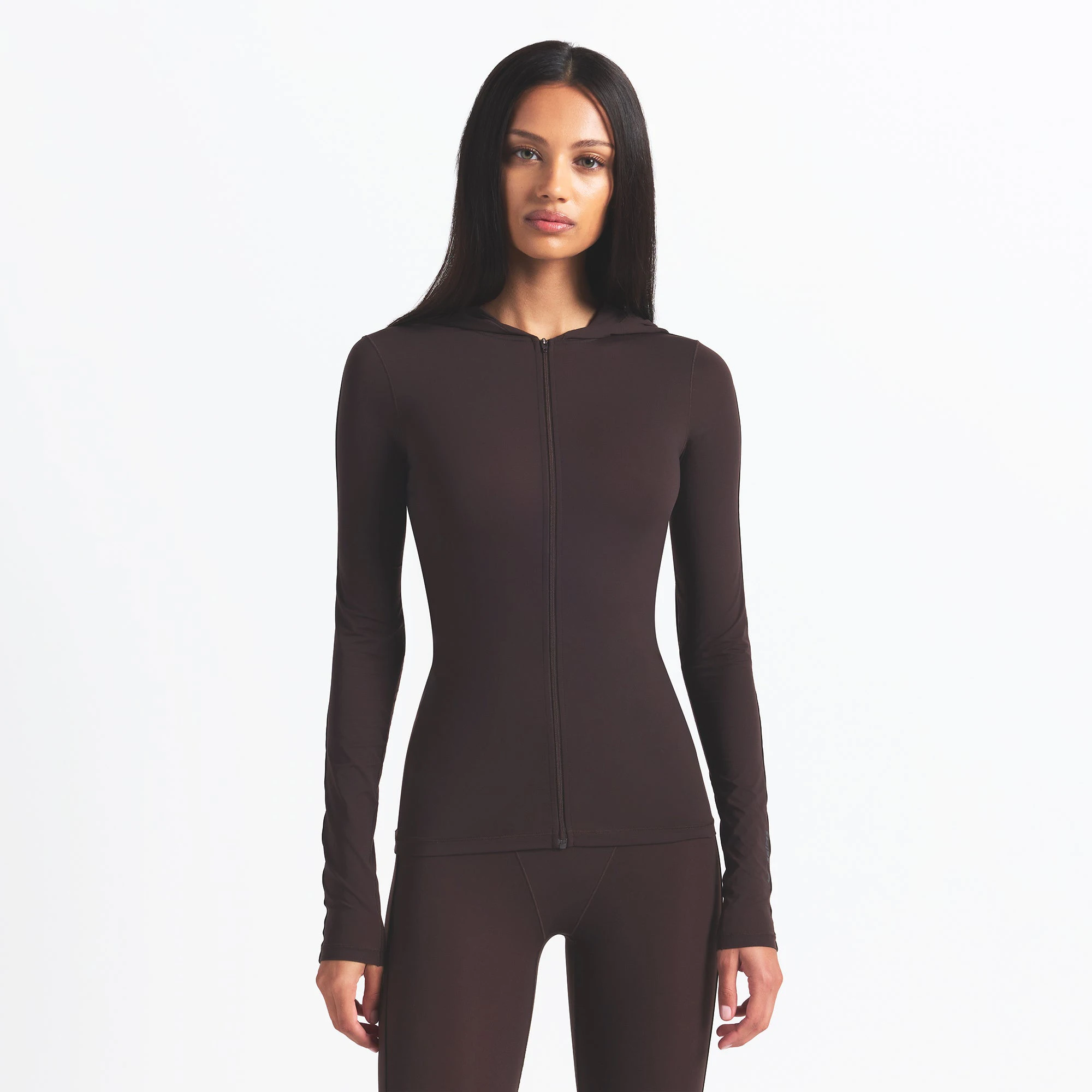 NikeSKIMS WEIGHTLESS LAYERS ZIP UP HOODIE | DARK ROAST ON A MODEL FRONT VIEW @ | FOCUS: 0.0, 1.0, 0.9