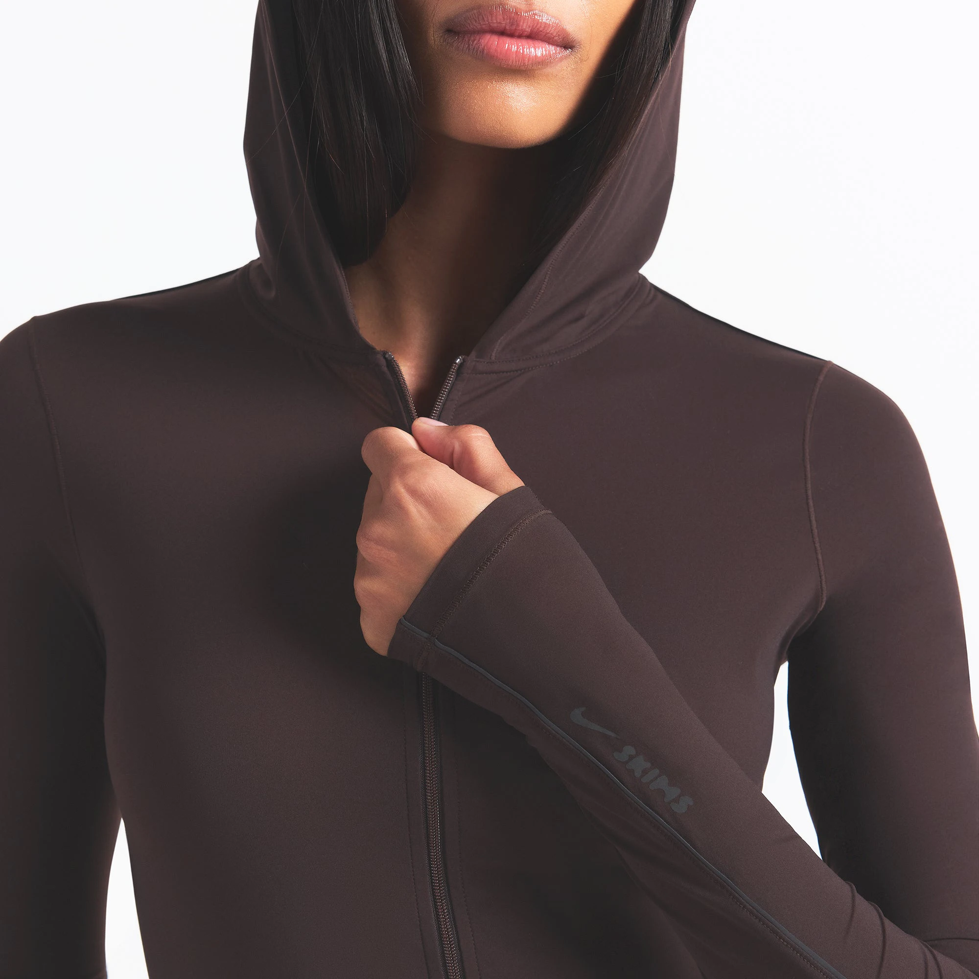 NikeSKIMS WEIGHTLESS LAYERS ZIP UP HOODIE | DARK ROAST ON A MODEL FRONT VIEW @ | FOCUS: 0.0, 1.0, 0.9