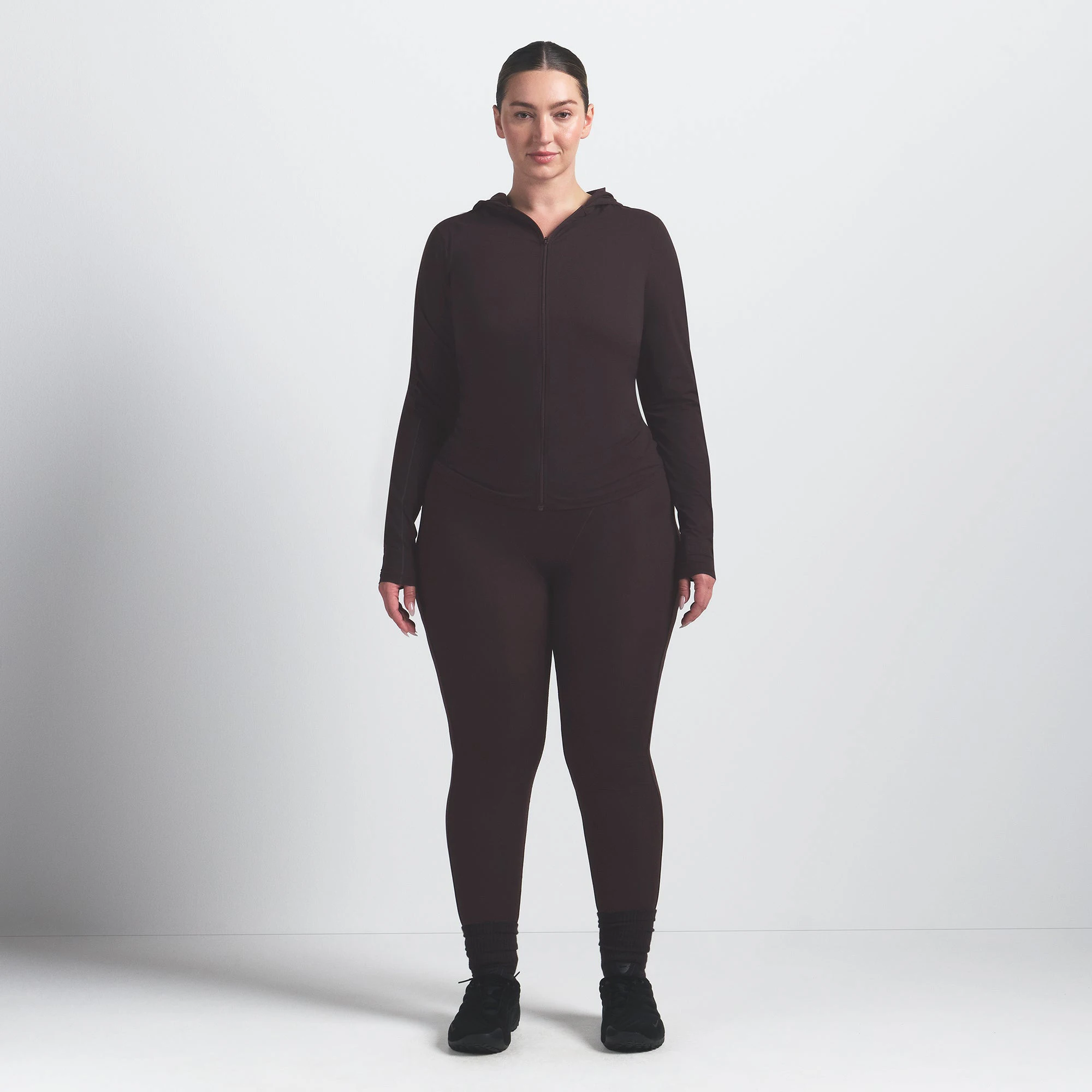 NikeSKIMS WEIGHTLESS LAYERS ZIP UP HOODIE | DARK ROAST ON A MODEL FRONT VIEW @ | FOCUS: 0.0, 1.0, 0.9