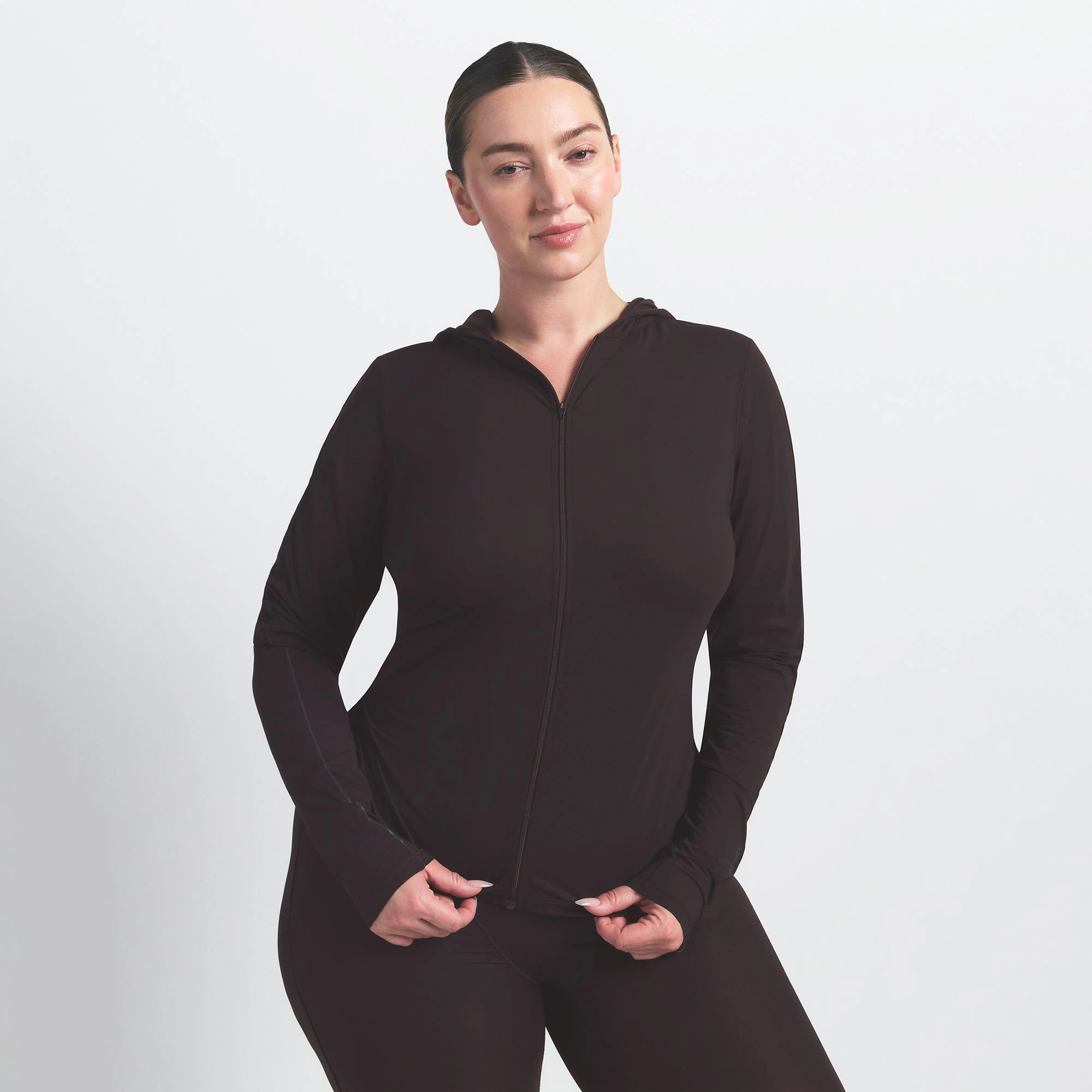 NikeSKIMS WEIGHTLESS LAYERS ZIP UP HOODIE | DARK ROAST ON A MODEL FRONT VIEW @ | FOCUS: 0.0, 1.0, 0.9