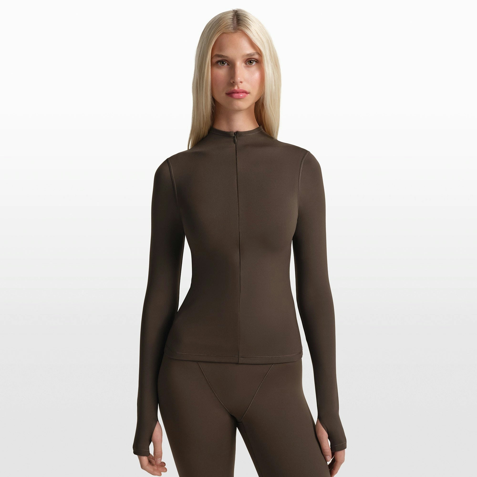 NikeSKIMS MATTE ZIP FRONT TOP | DARK SEPIA ON A MODEL FRONT VIEW @ | FOCUS: 0.0, 1.0, 0.9