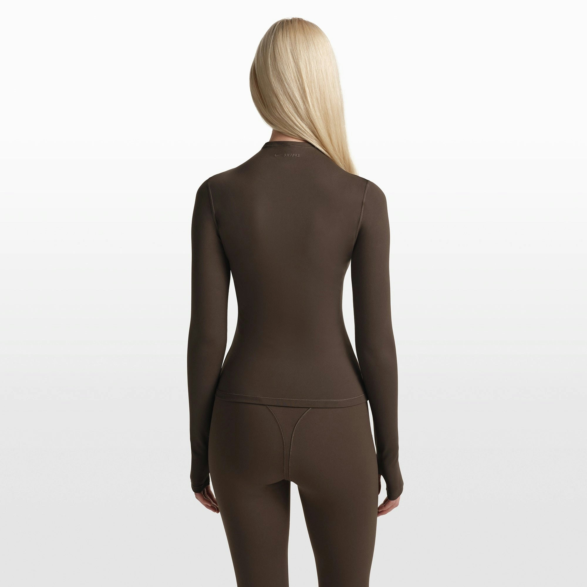 NikeSKIMS MATTE ZIP FRONT TOP | DARK SEPIA ON A MODEL FRONT VIEW @ | FOCUS: 0.0, 1.0, 0.9