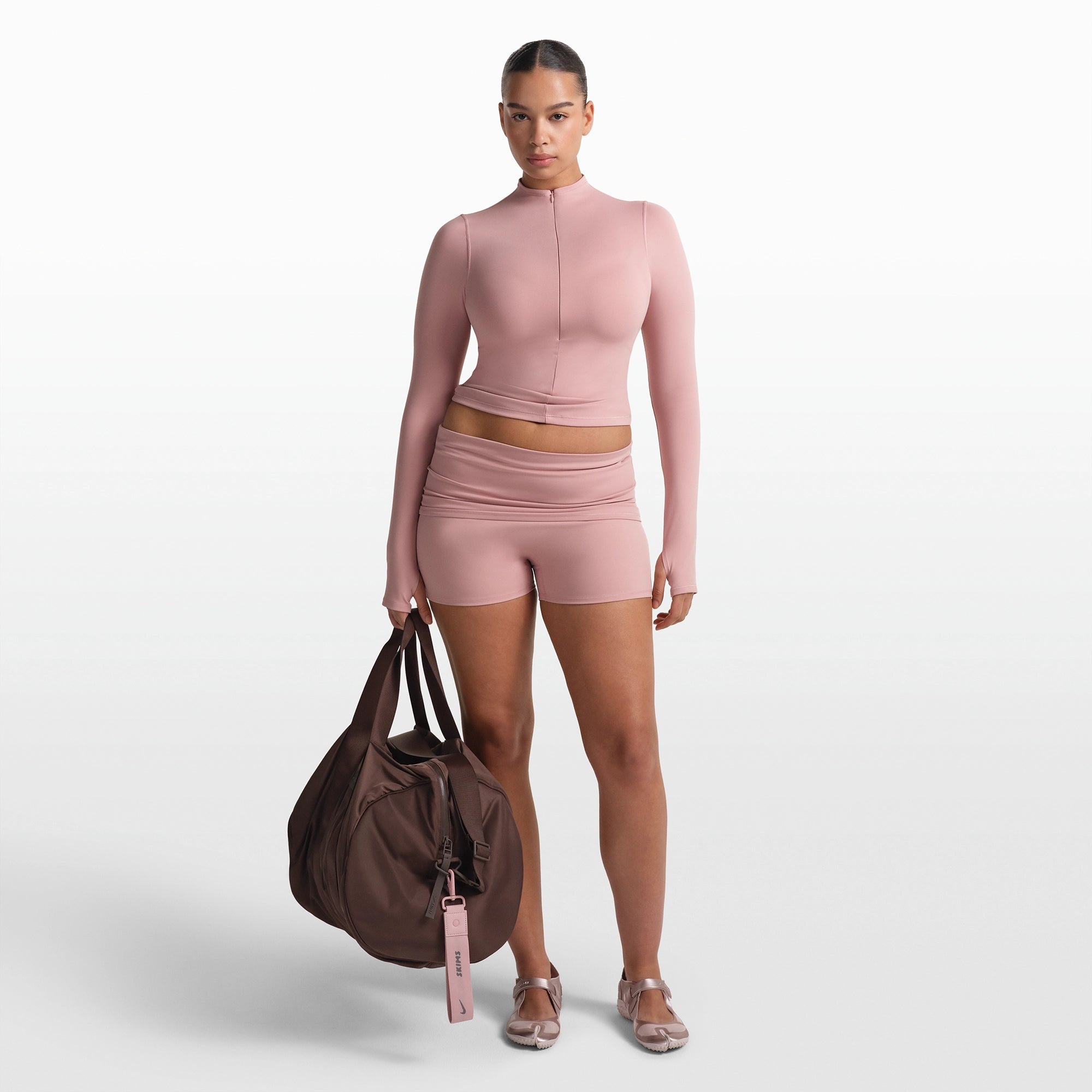 NikeSKIMS MATTE ZIP FRONT TOP | HIMALAYAN ON A MODEL FRONT VIEW @ | FOCUS: 0.0, 1.0, 0.9