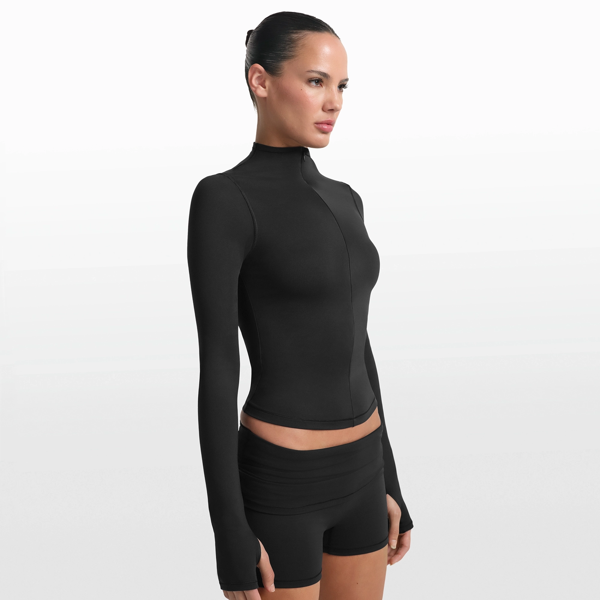 NikeSKIMS MATTE ZIP FRONT TOP | OBSIDIAN ON A MODEL FRONT VIEW @ | FOCUS: 0.0, 1.0, 0.9