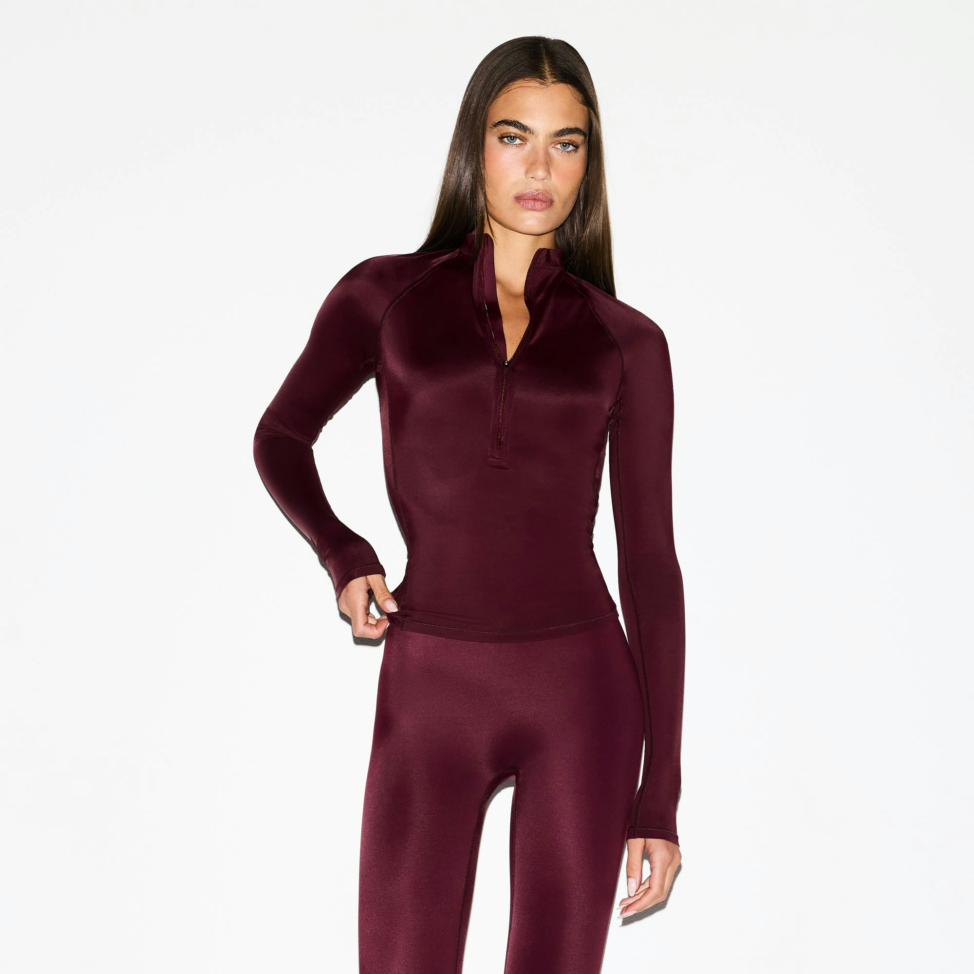 NikeSKIMS SHINE LONG SLEEVE HALF ZIP | CURRANT ON A MODEL SIDE VIEW @ | FOCUS: 0.0, 1.0, 0.9