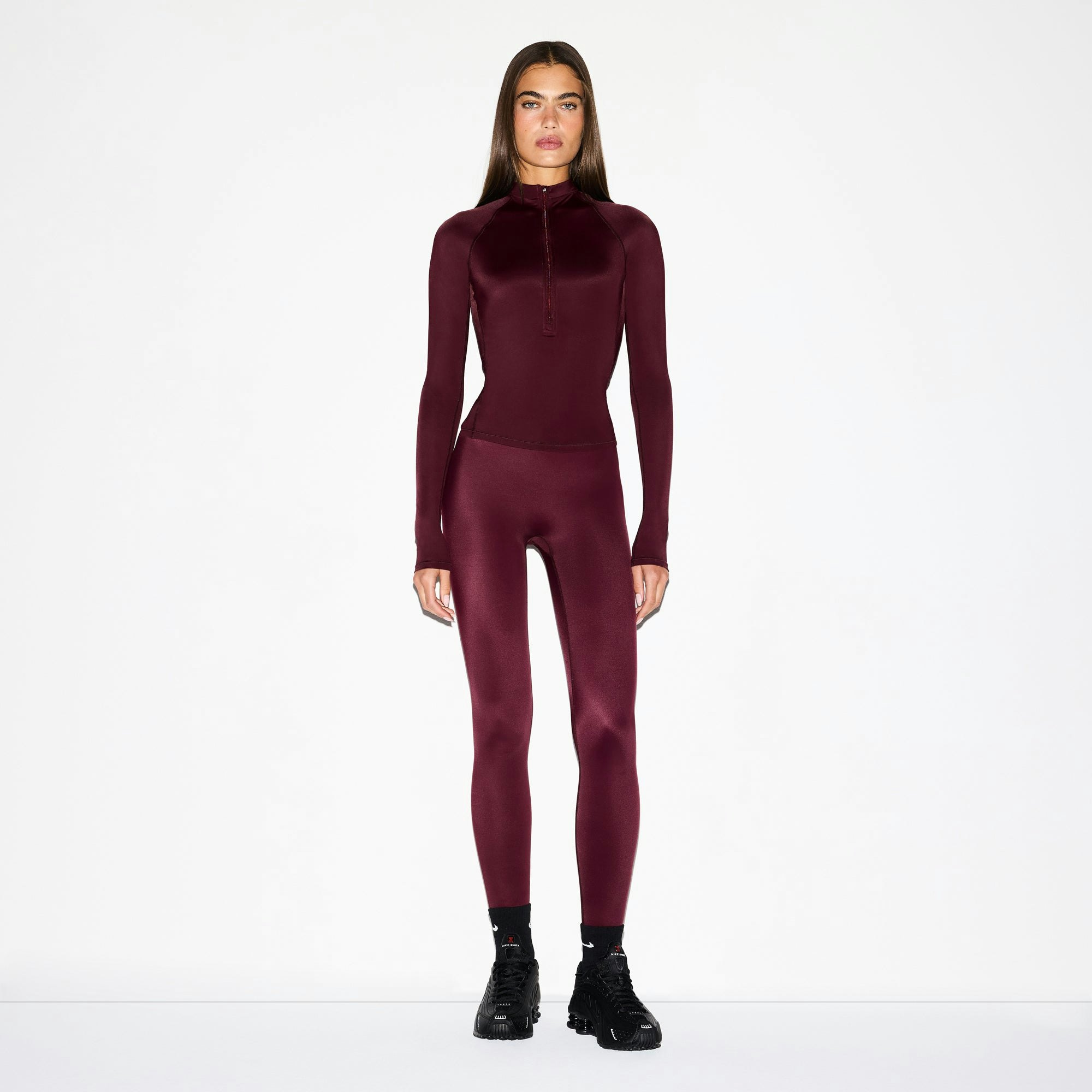NikeSKIMS SHINE LONG SLEEVE HALF ZIP | CURRANT ON A MODEL FRONT VIEW @ | FOCUS: 0.0, 1.0, 0.9