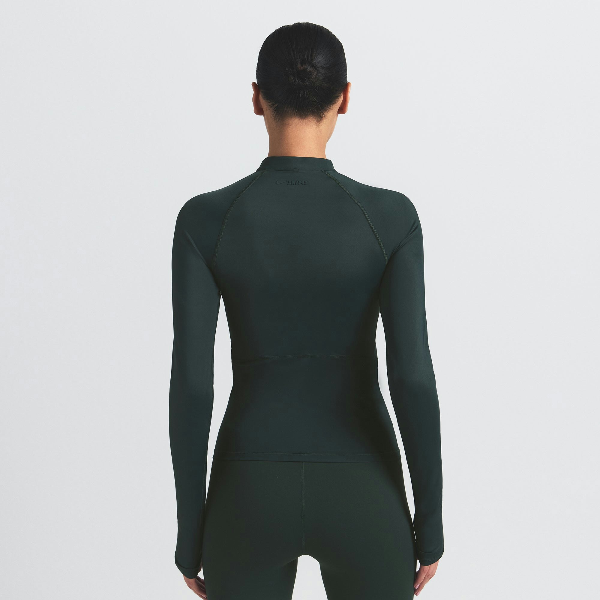 NikeSKIMS SHINE LONG SLEEVE HALF ZIP | DARK TEAL ON A MODEL SIDE VIEW @ | FOCUS: 0.0, 1.0, 0.9