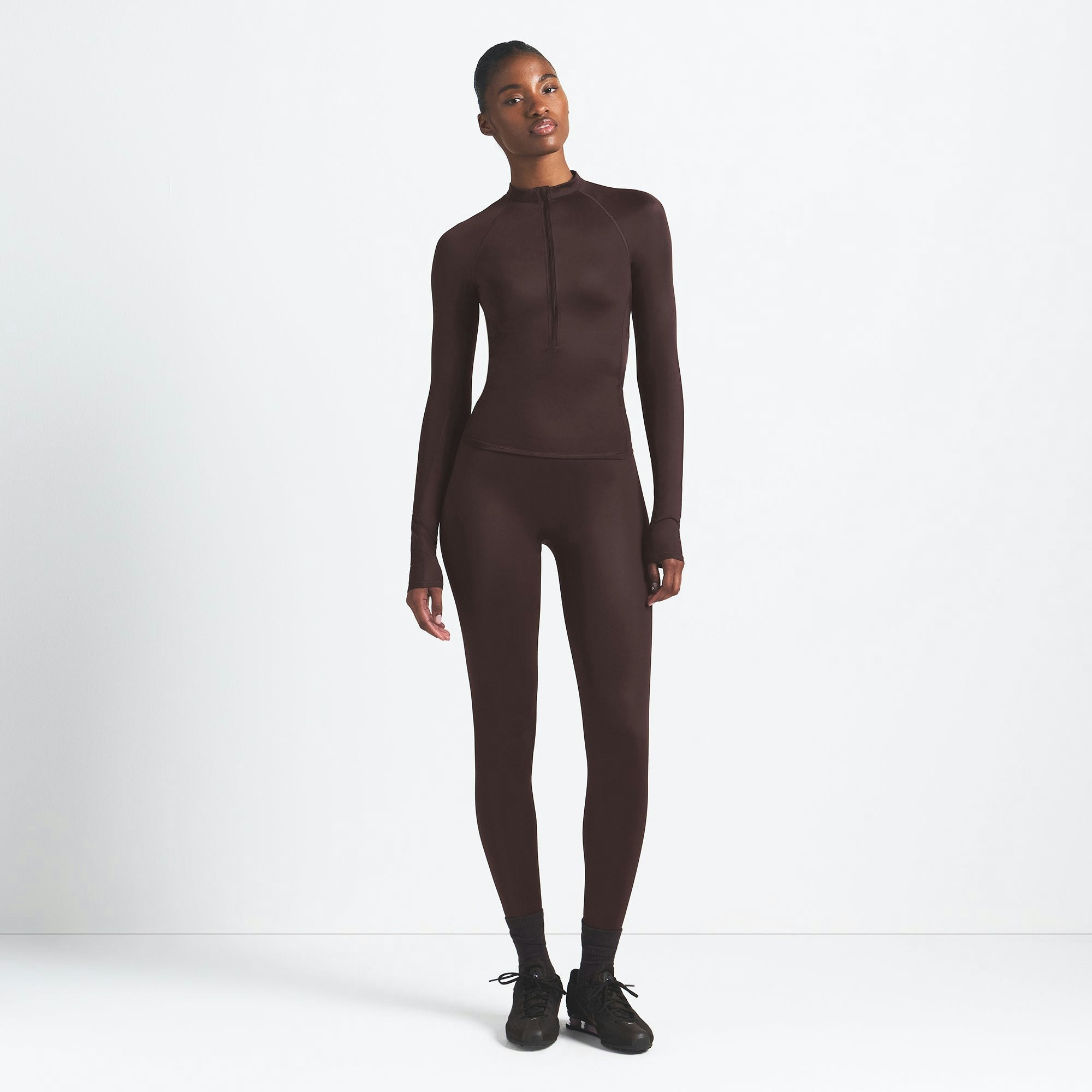 NikeSKIMS SHINE LONG SLEEVE HALF ZIP | PHOENIX ON A MODEL FRONT VIEW @ | FOCUS: 0.9, 0.1, 0.7