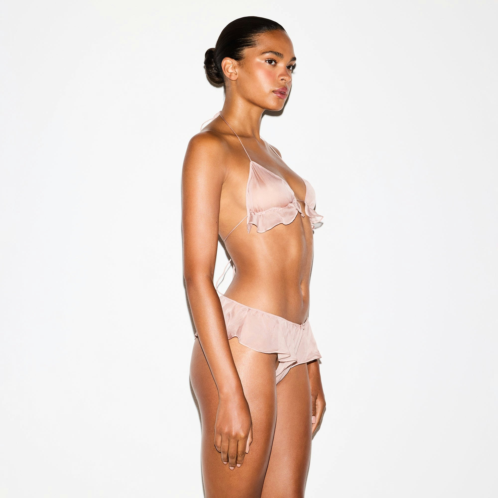 SKIMS ROMANCE TRIANGLE BRALETTE | LIGHT FAWN ON A MODEL SIDE VIEW @ | FOCUS: 0.0, 1.0, 0.9