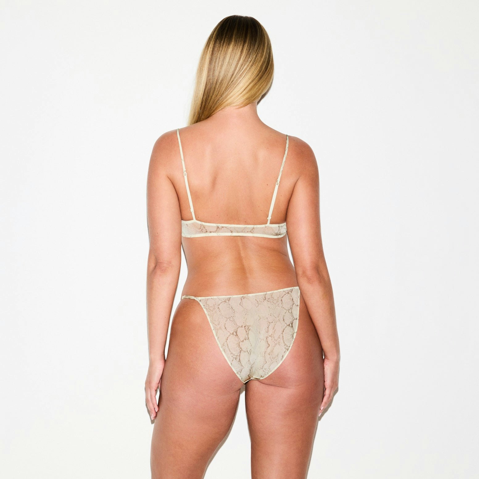 MILKY SHEER TRIANGLE BRALETTE | STONE PASTEL SNAKE PRINT ON A MODEL SIDE VIEW @ | FOCUS: 0.0, 1.0, 0.9