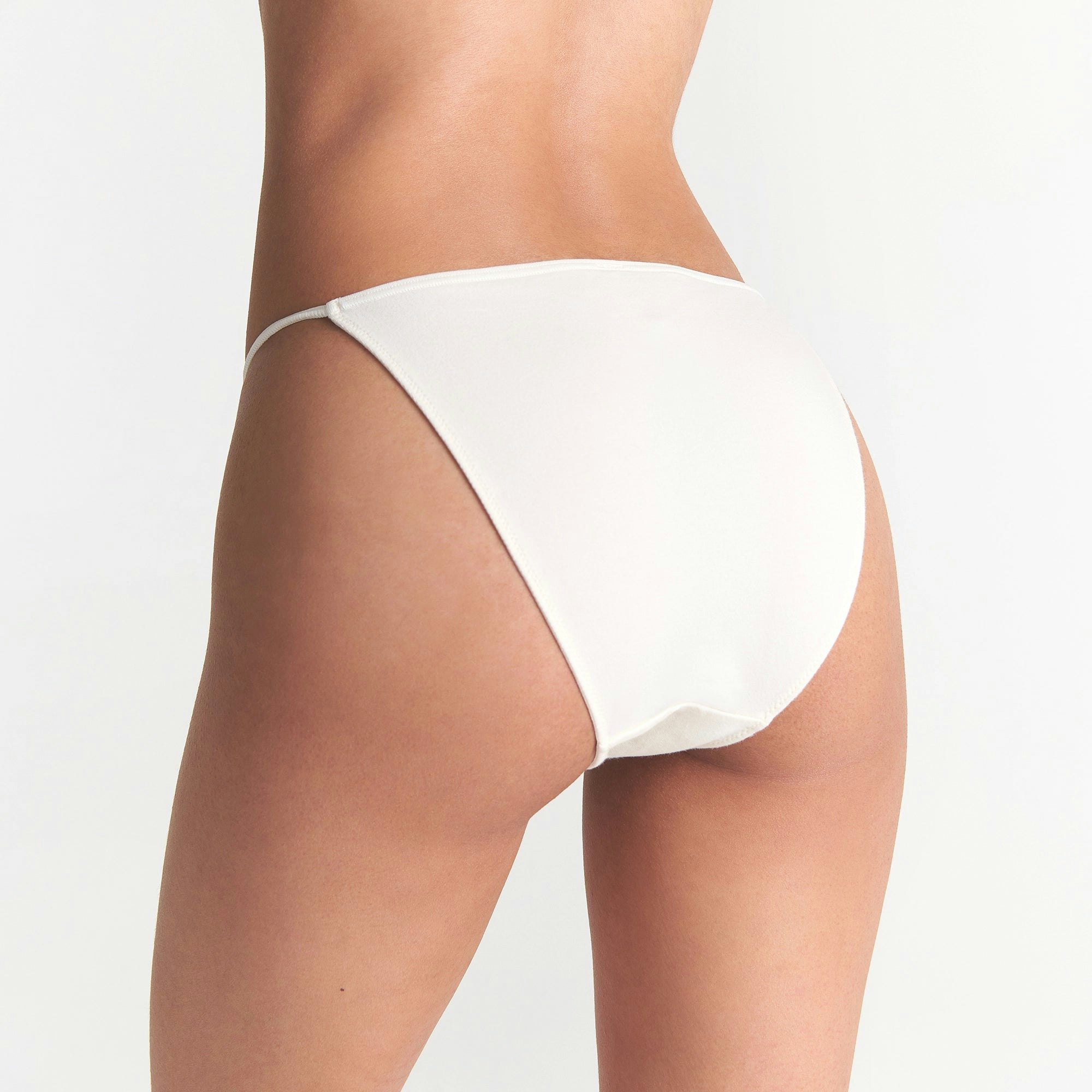 CACTUS PLANT FLEA MARKET X SKIMS COTTON JERSEY STRING BIKINI 5-PACK | SANTAS FAVORITE MULTI ON A MODEL BACK VIEW @ | FOCUS: 0.0, 1.0, 0.9