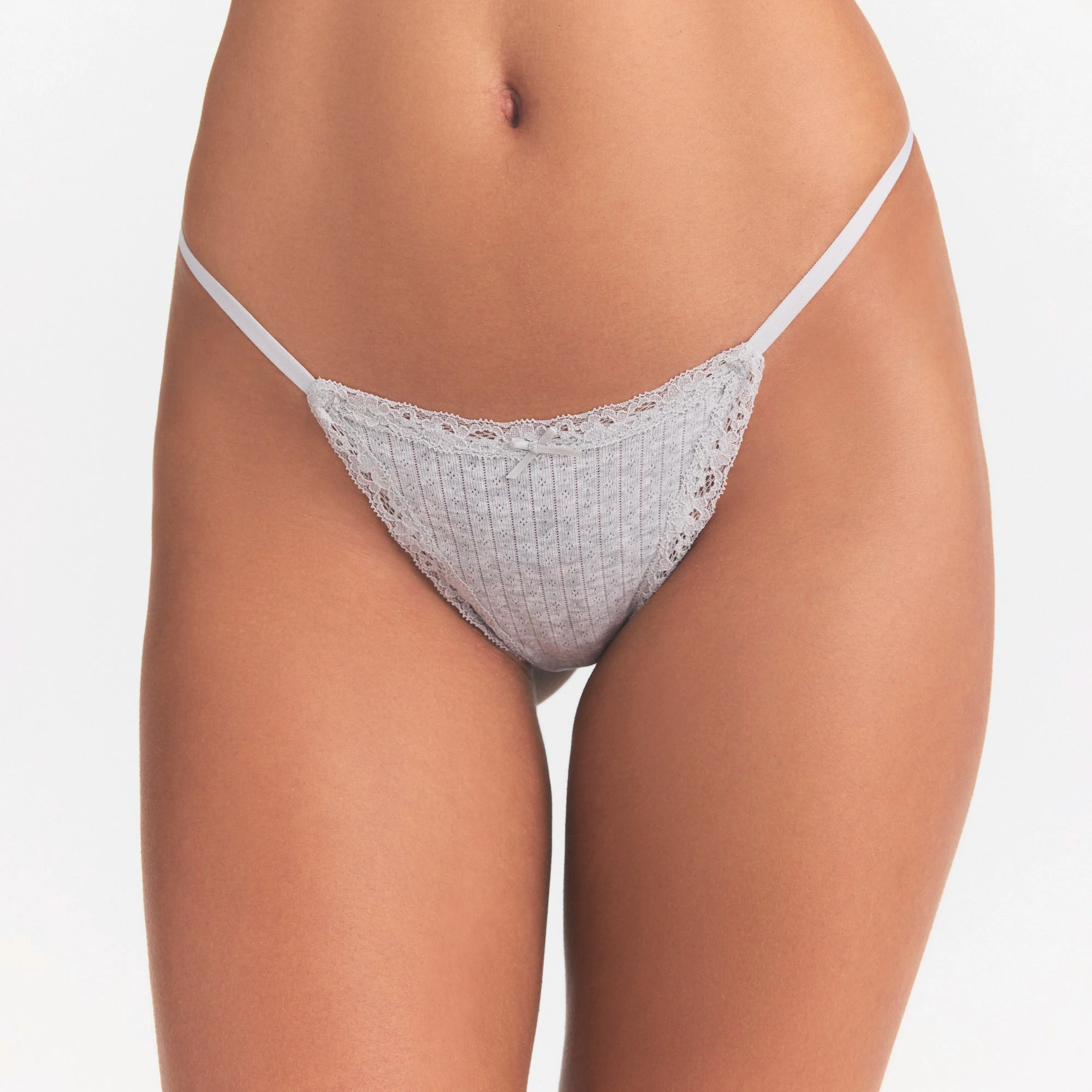 LIGHTWEIGHT COTTON POINTELLE LACE STRING THONG | LIGHT HEATHER GREY ON A MODEL SIDE VIEW | FOCUS: 0.0, 1.0, 0.9