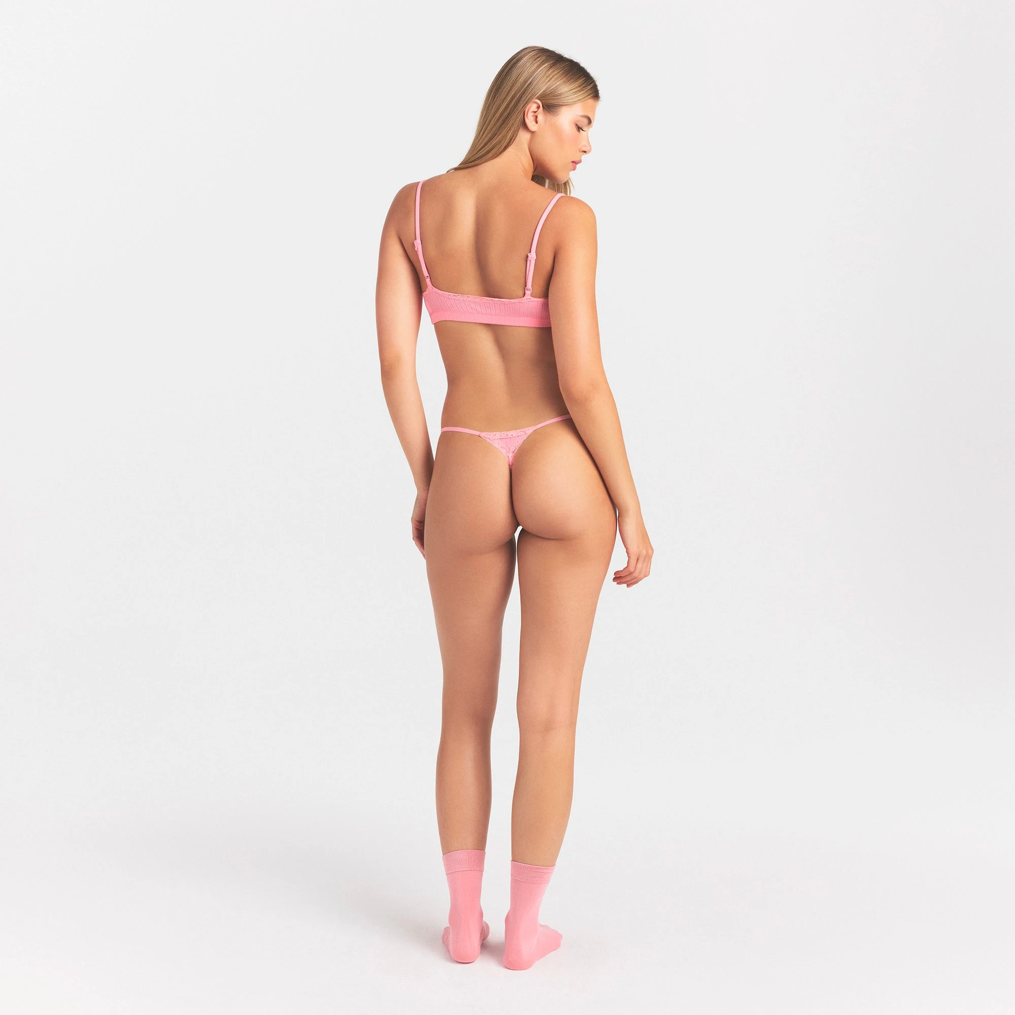 LIGHTWEIGHT COTTON POINTELLE LACE STRING THONG | MELON TONAL ON A MODEL SIDE VIEW @ | FOCUS: 0.0, 1.0, 0.9
