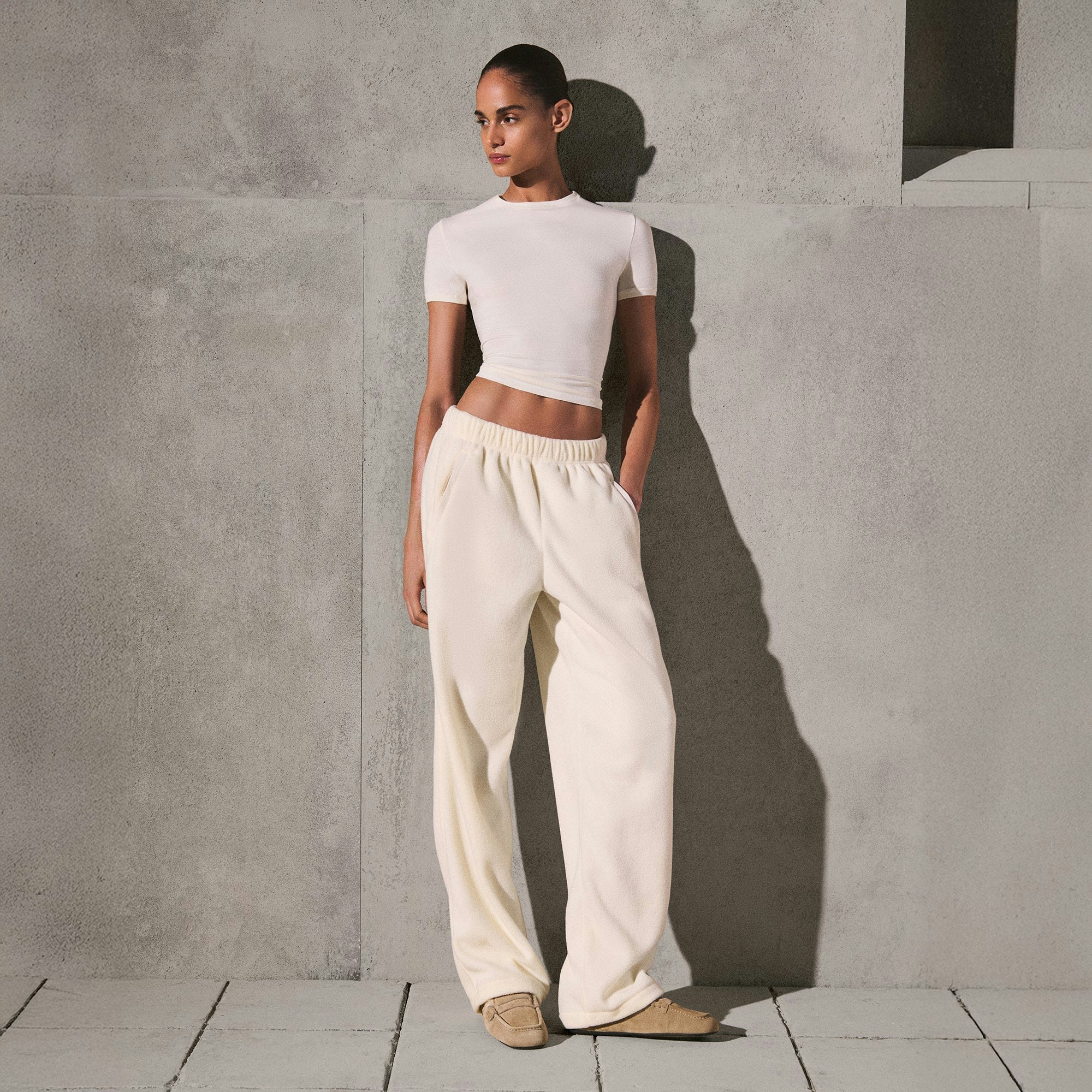 OUTDOOR FLEECE STRAIGHT LEG PANT | ECRU ON A MODEL SIDE VIEW @ | FOCUS: 0.0, 1.0, 0.9