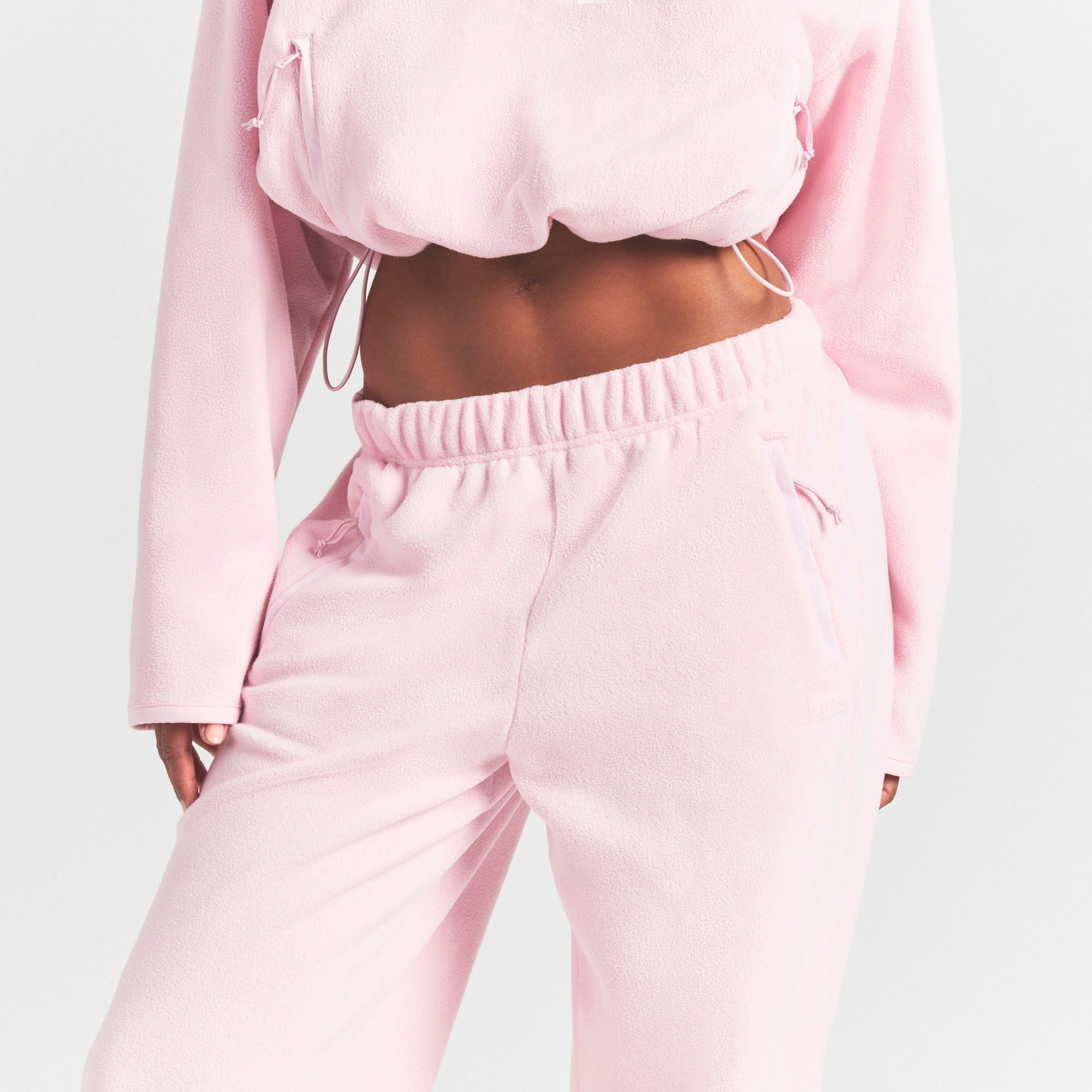 OUTDOOR FLEECE STRAIGHT LEG PANT | CHERRY BLOSSOM ON A MODEL SIDE VIEW @ | FOCUS: 0.0, 1.0, 0.9