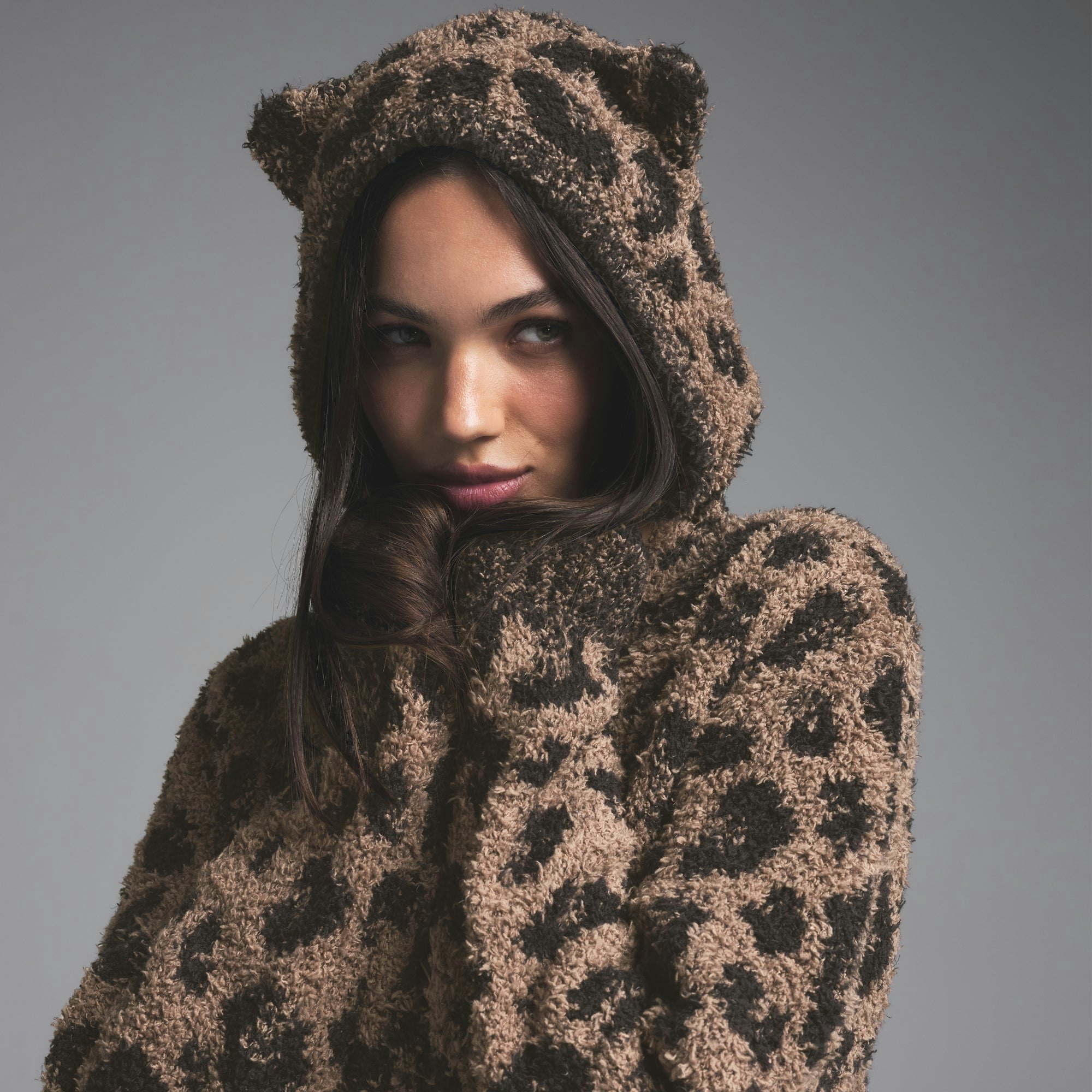 COZY KNIT ANIMAL EAR HOODIE | LEOPARD PRINT ON A MODEL SIDE VIEW | FOCUS: 0.0, 1.0, 0.9