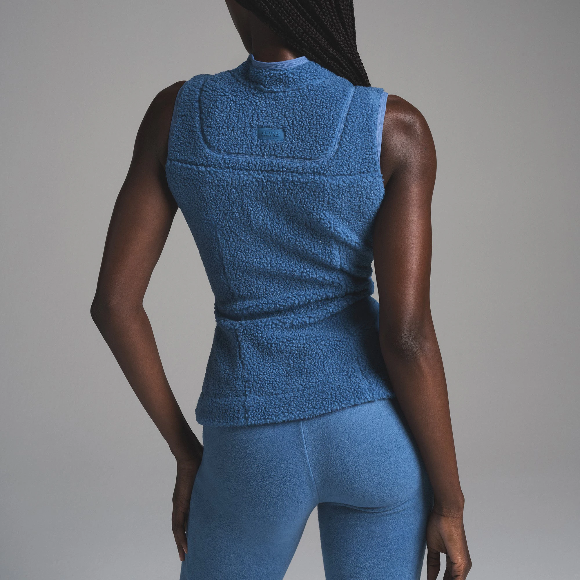 TEDDY ZIP UP VEST | AZURE ON A MODEL SIDE VIEW | FOCUS: 0.0, 1.0, 0.9