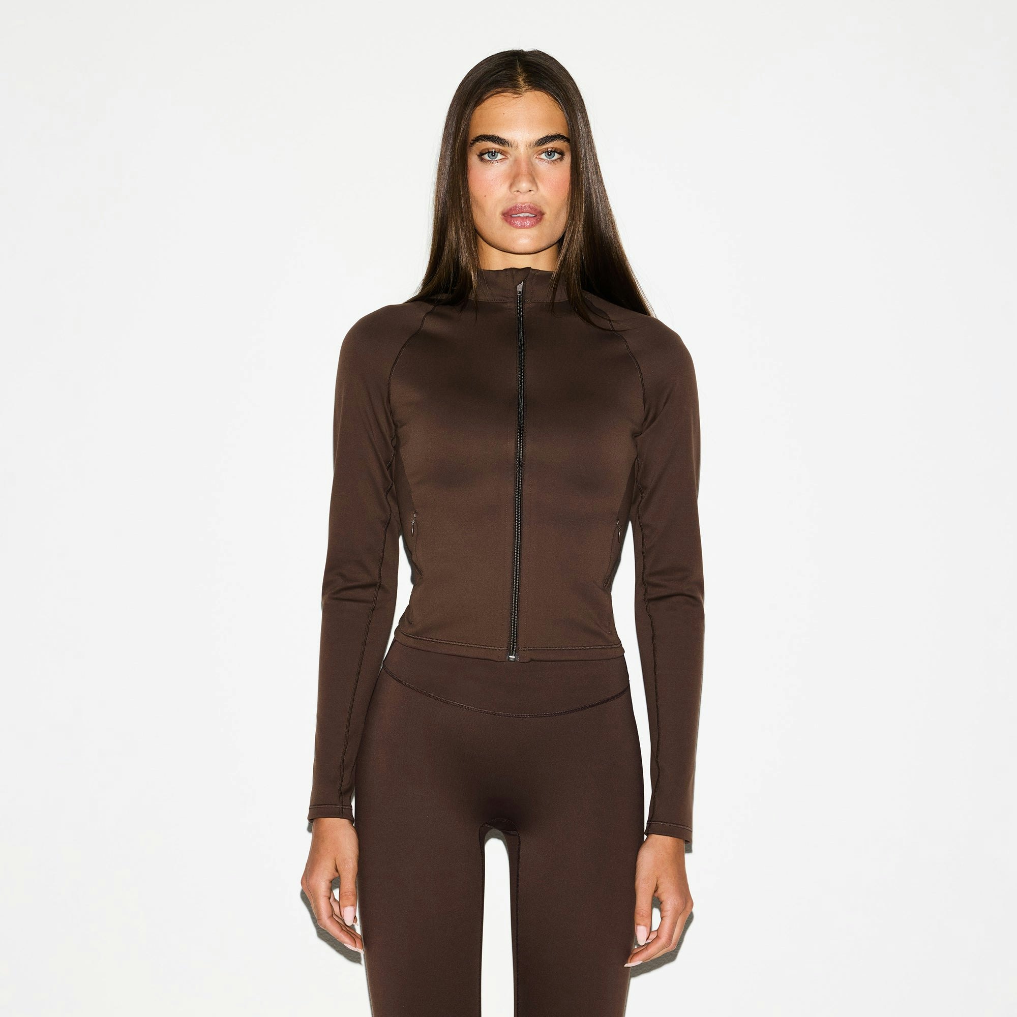 NikeSKIMS MATTE MOCK NECK FULL ZIP JACKET | DARK SEPIA ON A MODEL FRONT VIEW @ | FOCUS: 0.0, 1.0, 0.9