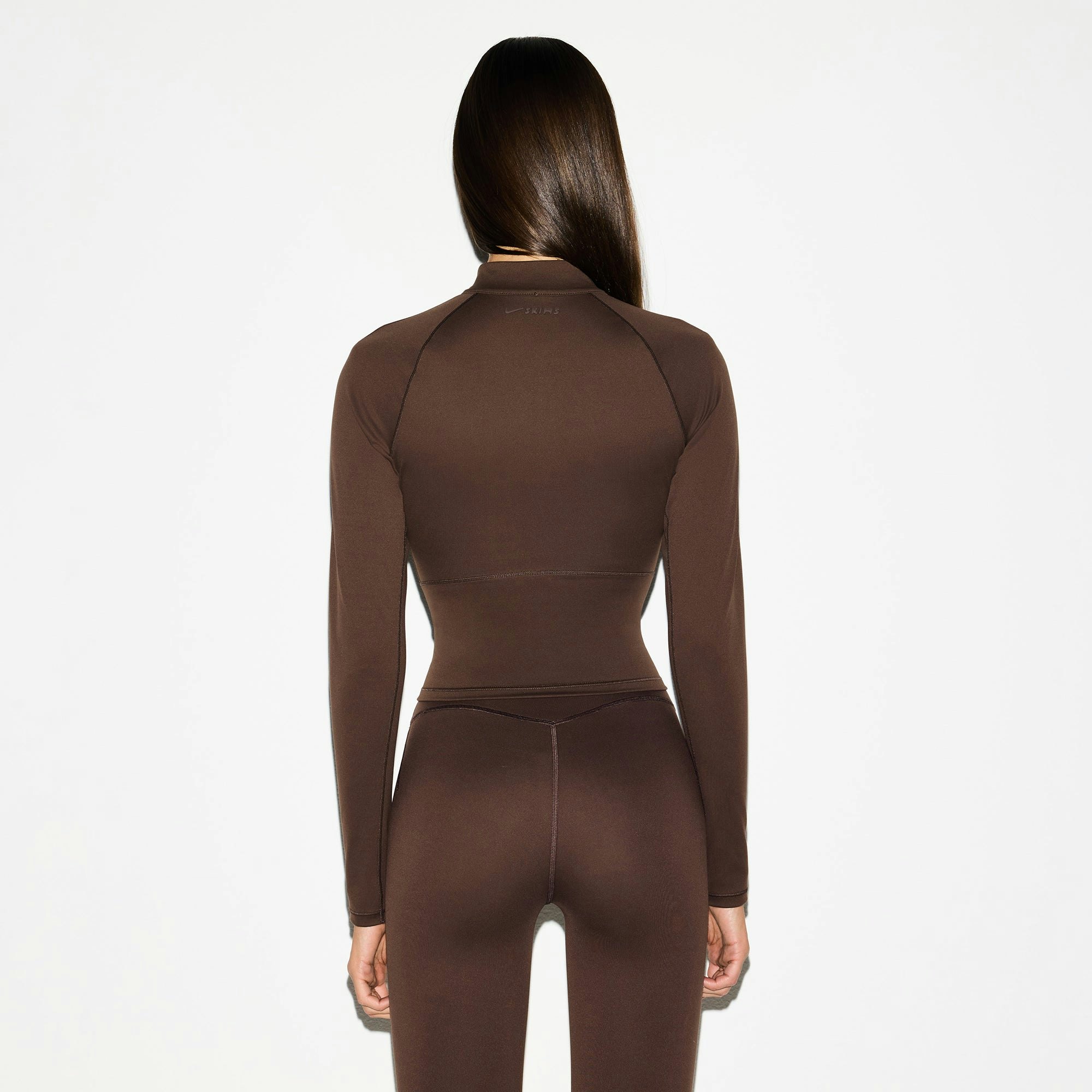 NikeSKIMS MATTE MOCK NECK FULL ZIP JACKET | DARK SEPIA ON A MODEL BACK VIEW @ | FOCUS: 0.0, 1.0, 0.9