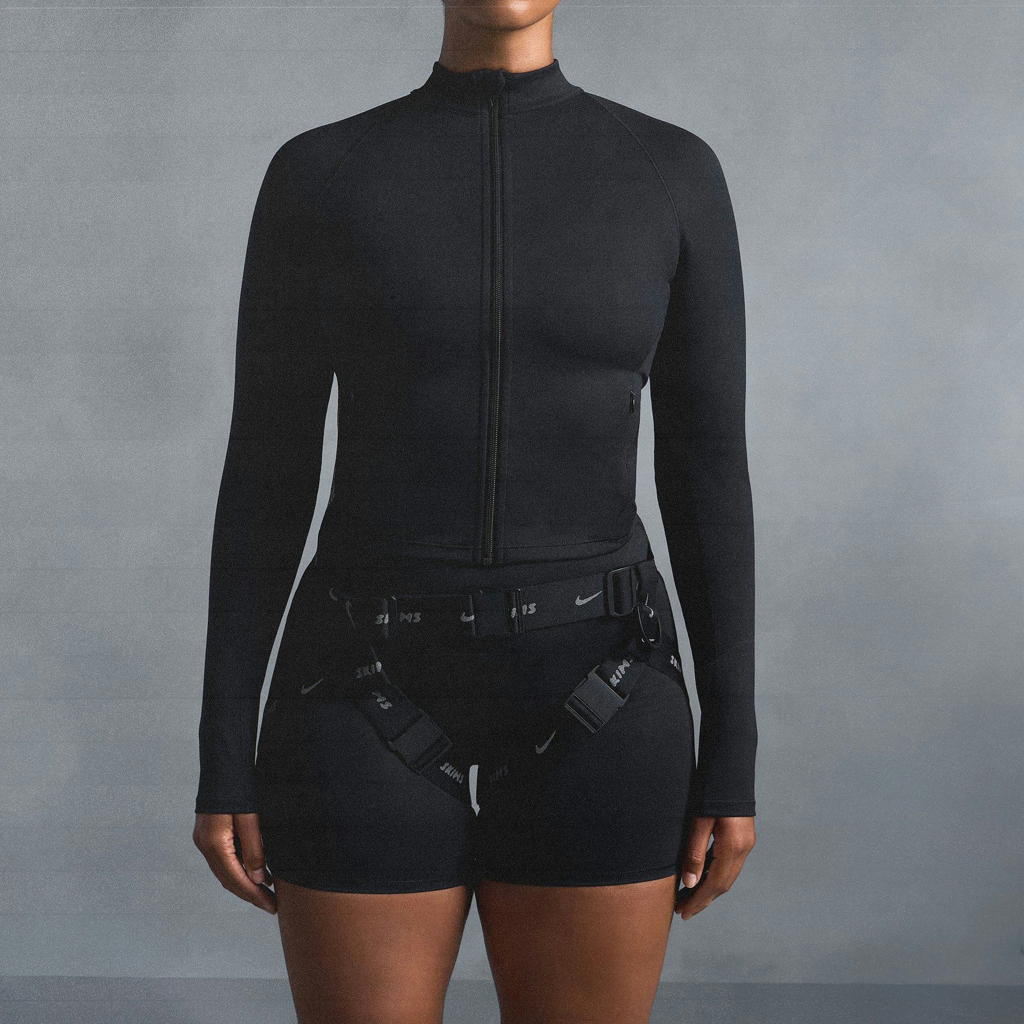 NikeSKIMS MATTE MOCK NECK FULL ZIP JACKET | OBSIDIAN ON A MODEL SIDE VIEW @ | FOCUS: 0.0, 1.0, 0.9