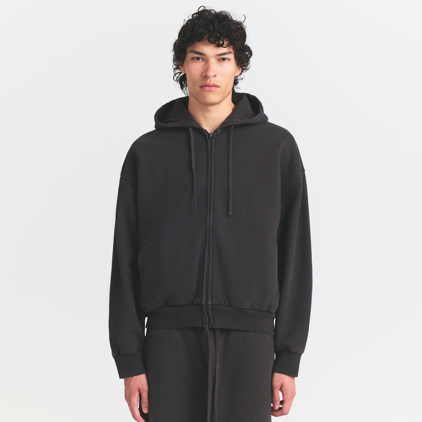 HEAVYWEIGHT FLEECE MENS ZIP UP HOODIE | WASHED ONYX ON A MODEL SIDE VIEW @ | FOCUS: 0.0, 1.0, 0.9