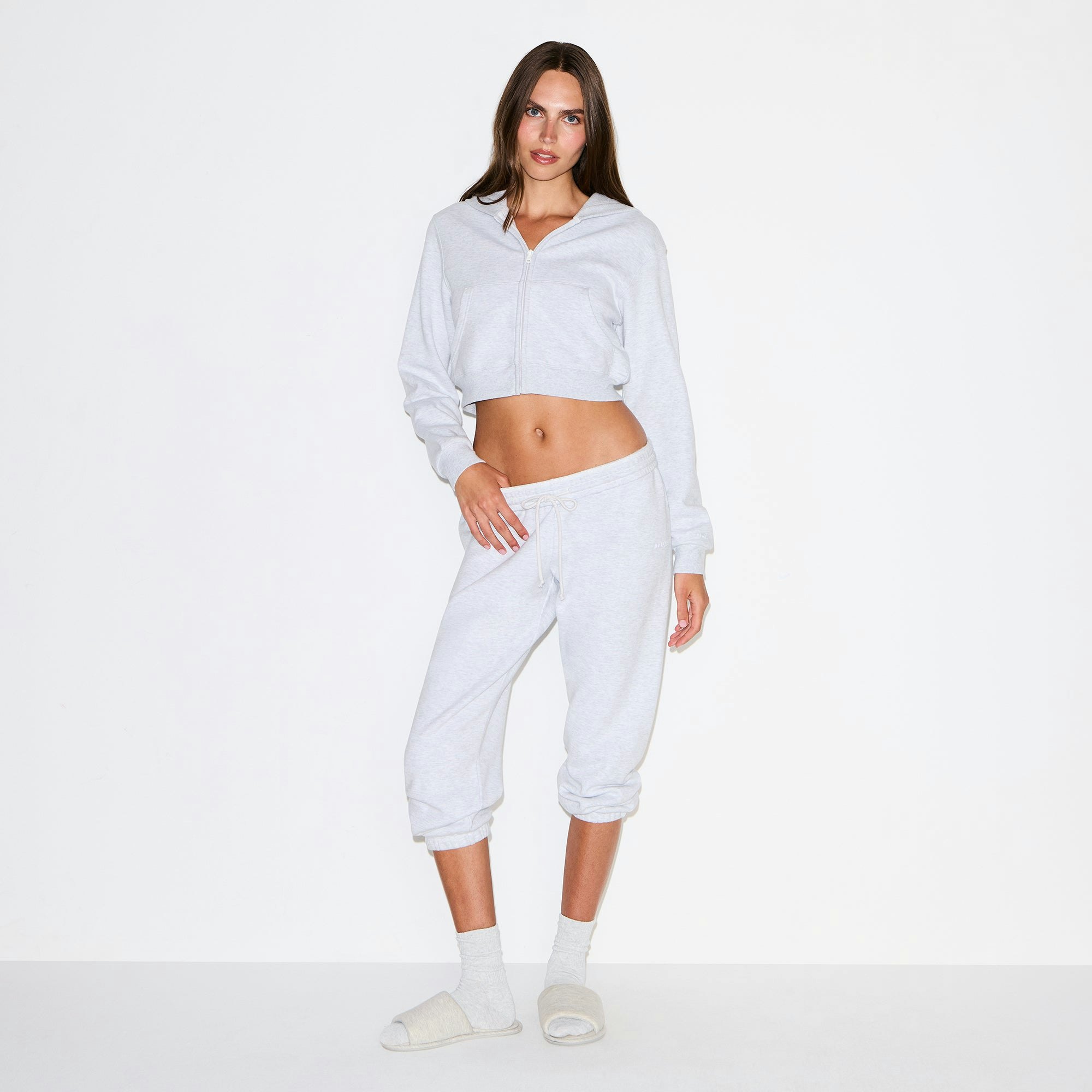 COTTON FLEECE CROPPED ZIP UP HOODIE | LIGHT HEATHER GREY ON A MODEL FRONT VIEW @ | FOCUS: 0.9, 0.1, 0.7