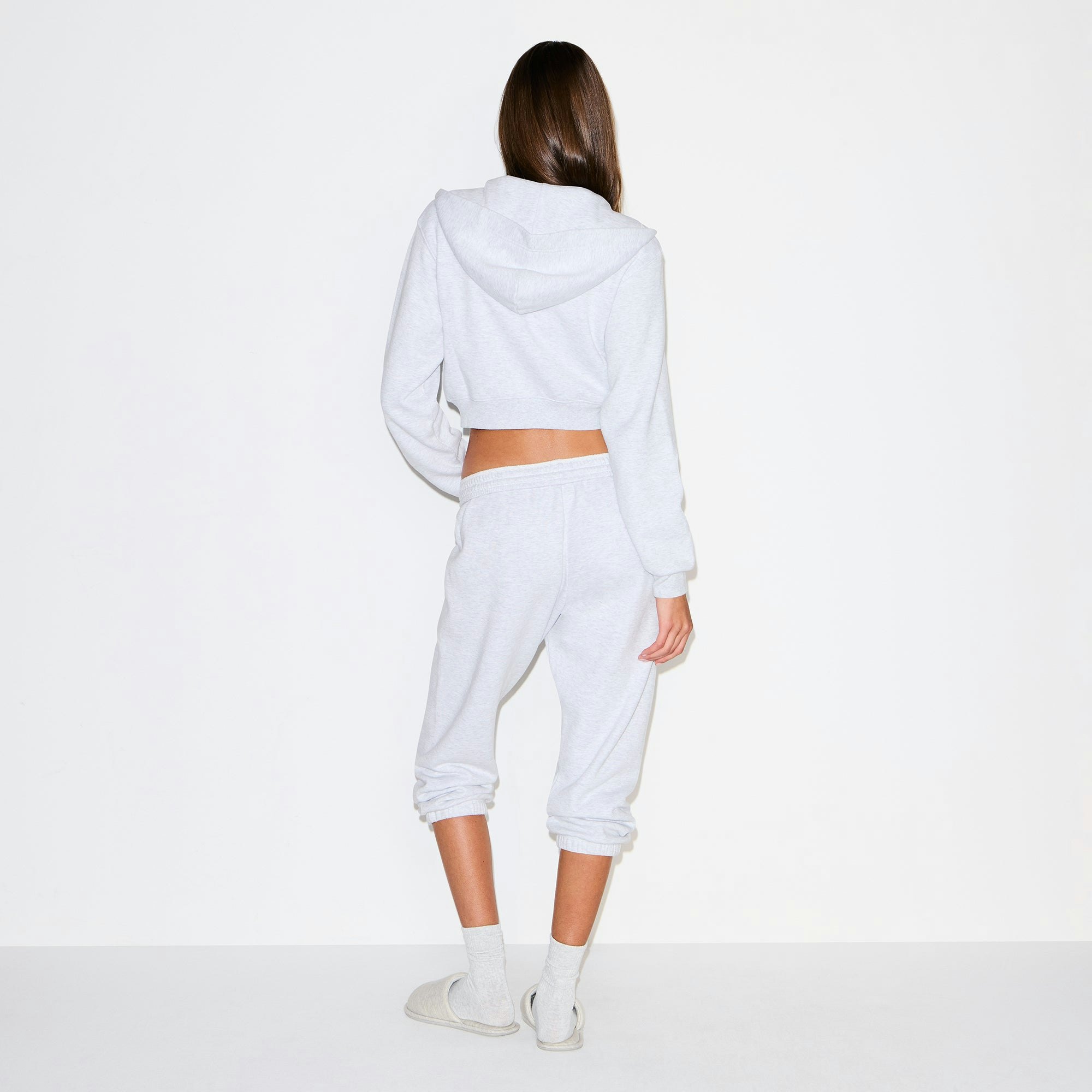COTTON FLEECE CROPPED ZIP UP HOODIE | LIGHT HEATHER GREY ON A MODEL BACK VIEW @ | FOCUS: 0.9, 0.1, 0.7