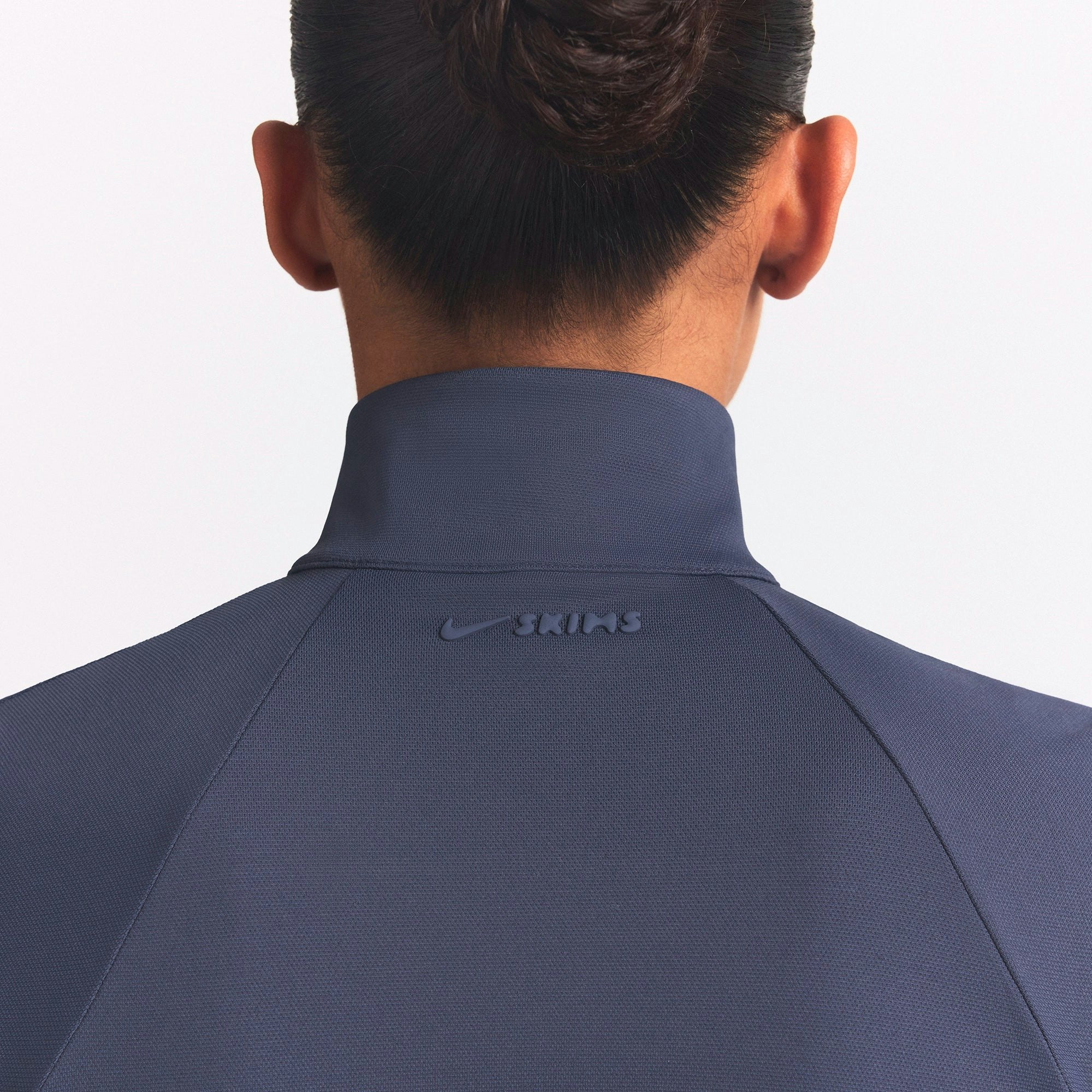 NikeSKIMS AIRY TRACK JACKET | DEEP ROYAL ON A MODEL SIDE VIEW @ | FOCUS: 0.0, 1.0, 0.9