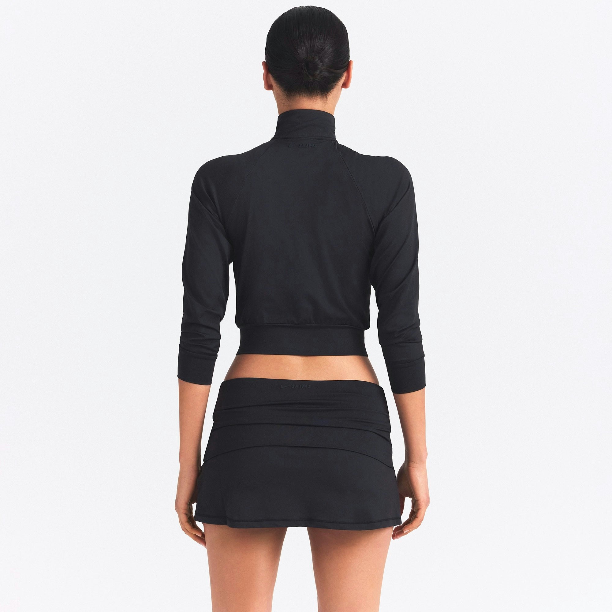 NikeSKIMS AIRY TRACK JACKET | OBSIDIAN ON A MODEL SIDE VIEW @ | FOCUS: 0.0, 1.0, 0.9