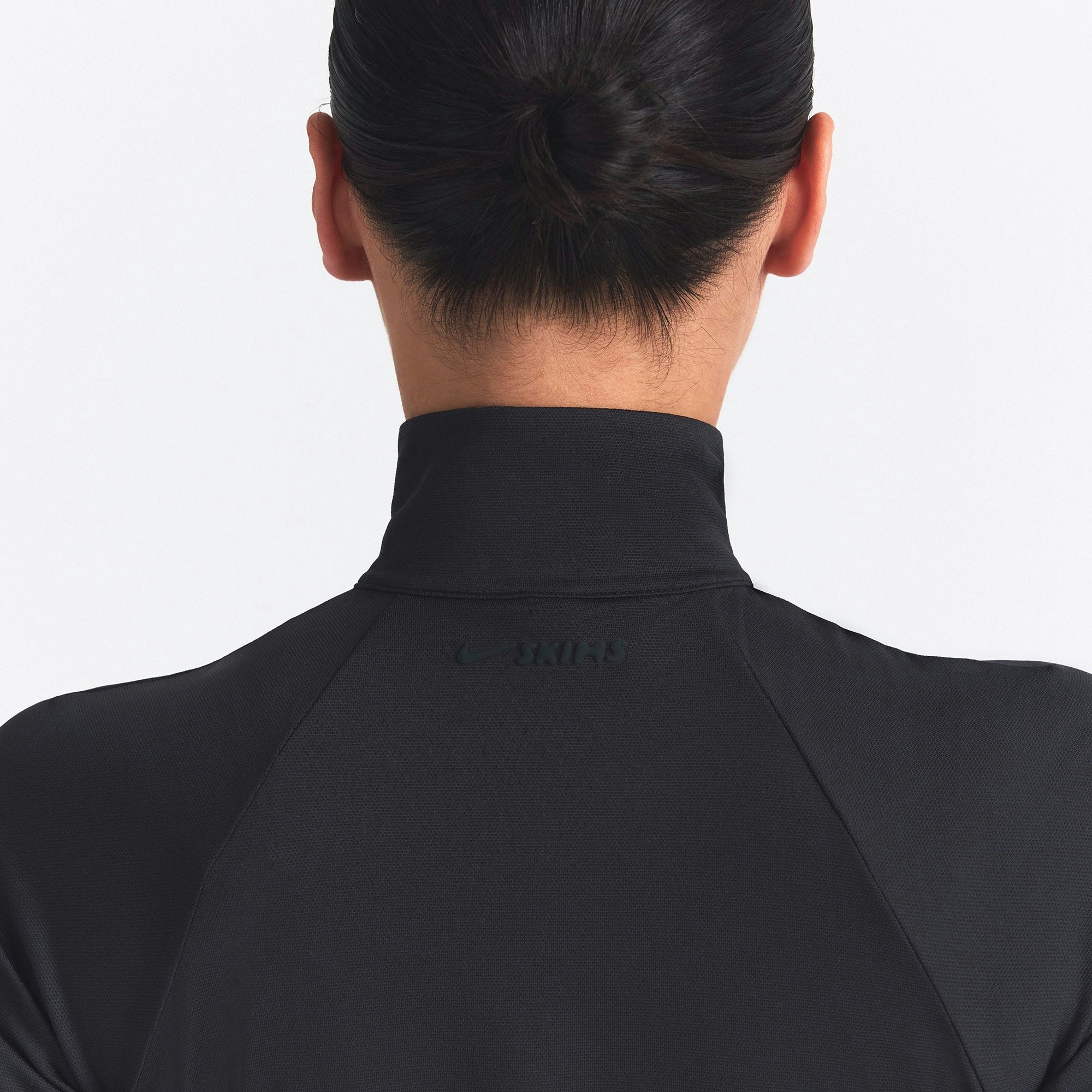 NikeSKIMS AIRY TRACK JACKET | OBSIDIAN ON A MODEL SIDE VIEW @ | FOCUS: 0.0, 1.0, 0.9