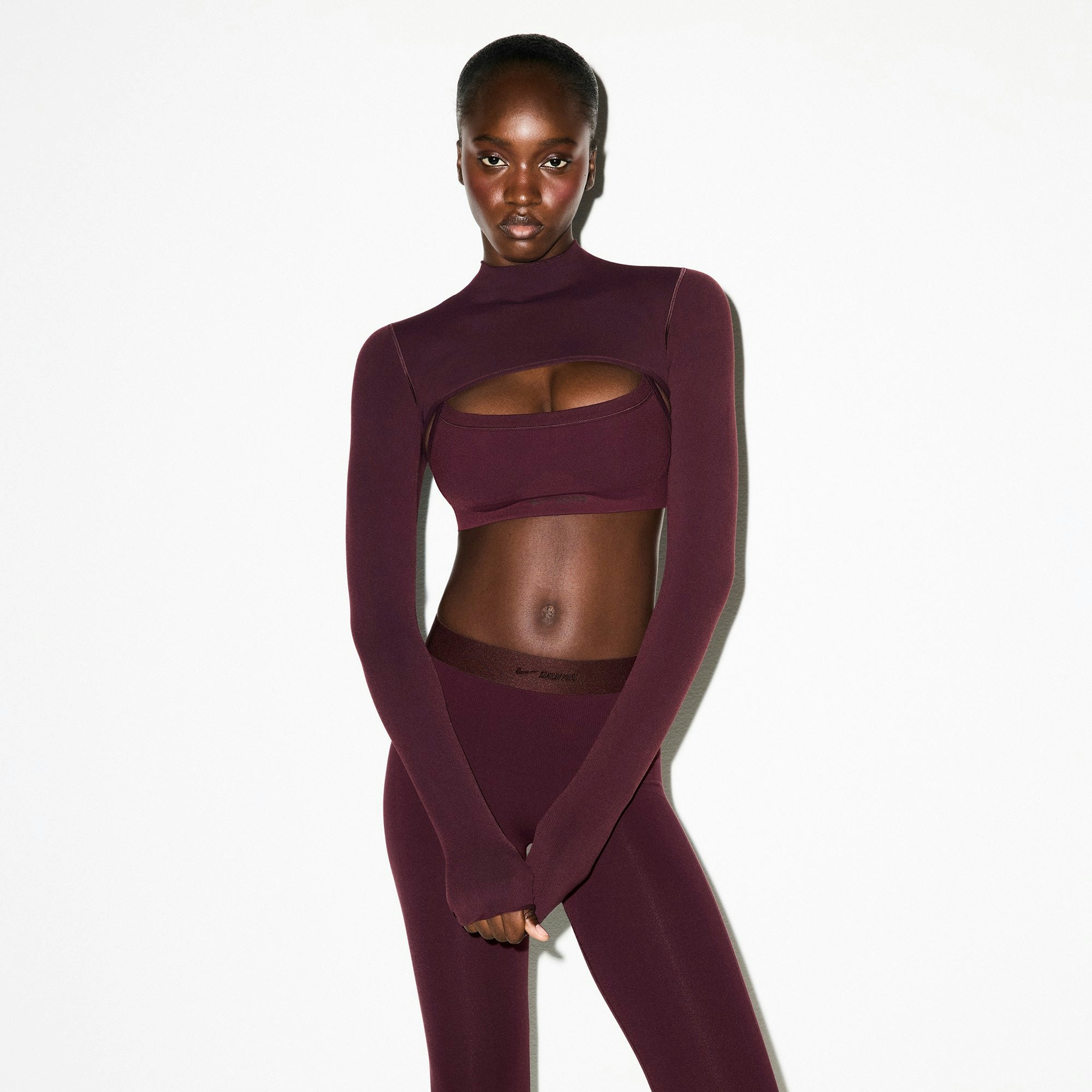 NikeSKIMS VINTAGE SEAMLESS SHRUG | CURRANT ON A MODEL FRONT VIEW @ | FOCUS: 0.0, 1.0, 0.9