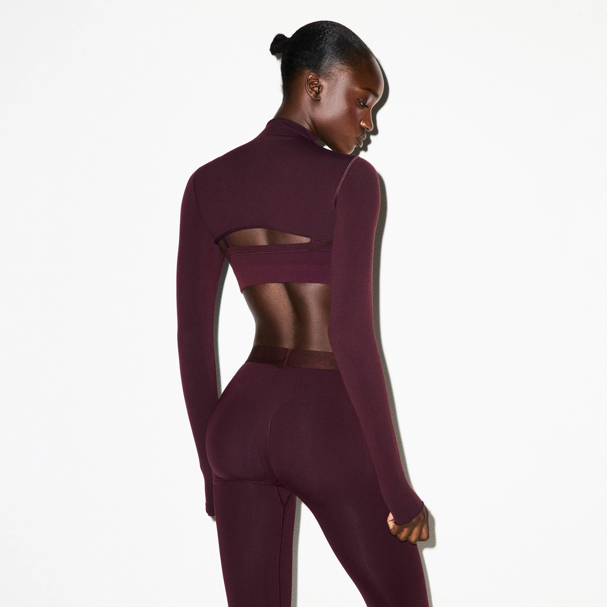 NikeSKIMS VINTAGE SEAMLESS SHRUG | CURRANT ON A MODEL FRONT VIEW @ | FOCUS: 0.0, 1.0, 0.9