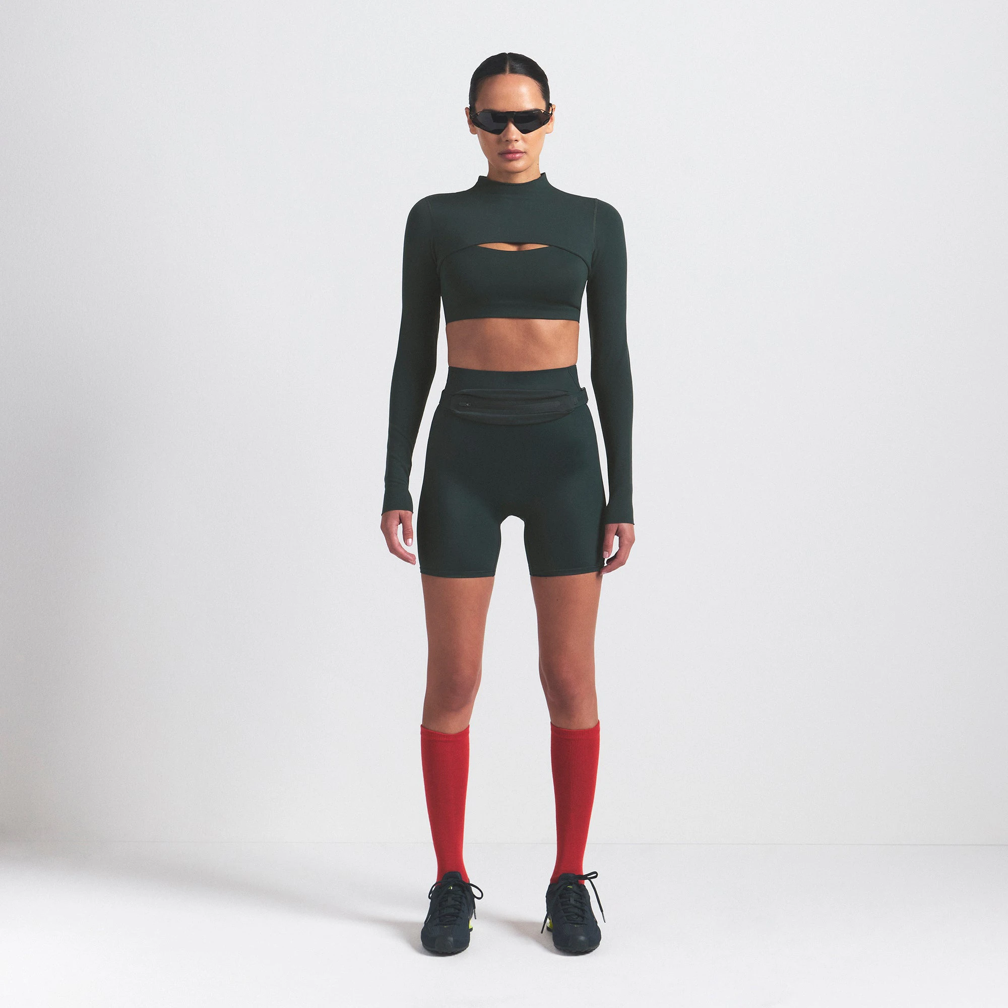 NikeSKIMS VINTAGE SEAMLESS SHRUG | DARK TEAL ON A MODEL FRONT VIEW @ | FOCUS: 0.0, 1.0, 0.9