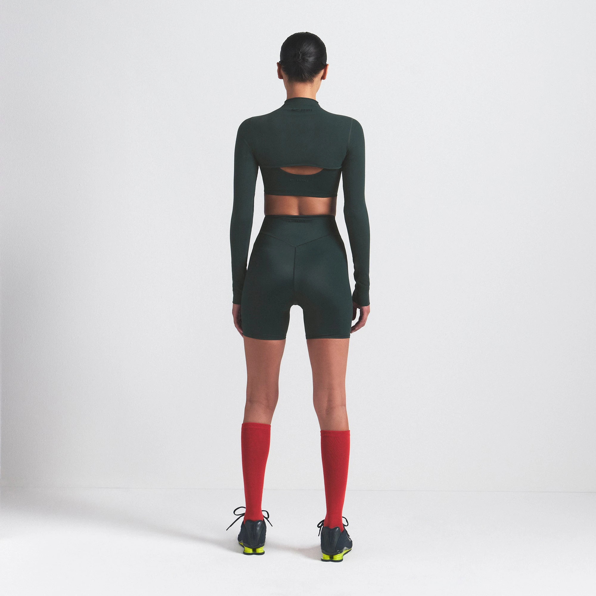 NikeSKIMS VINTAGE SEAMLESS SHRUG | DARK TEAL ON A MODEL SIDE VIEW @ | FOCUS: 0.0, 1.0, 0.9