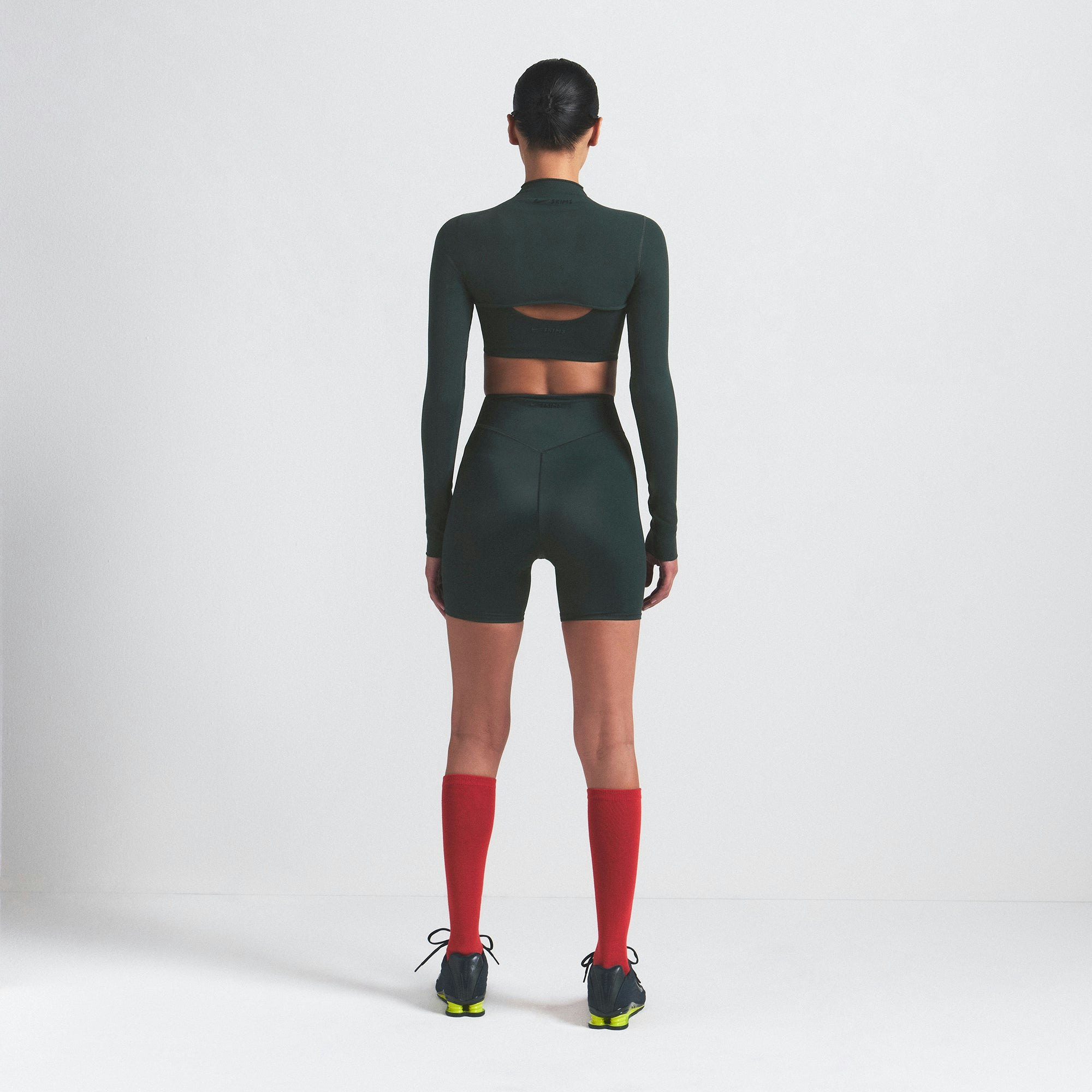 NikeSKIMS VINTAGE SEAMLESS SHRUG | DARK TEAL ON A MODEL SIDE VIEW @ | FOCUS: 0.0, 1.0, 0.9