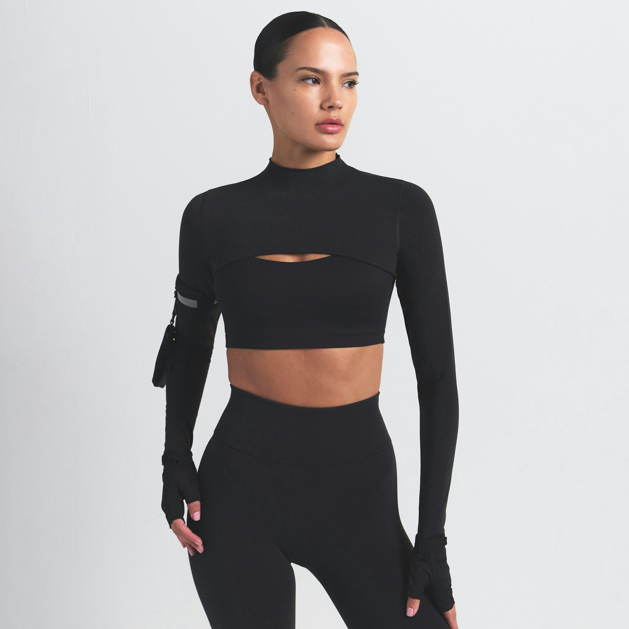 NikeSKIMS VINTAGE SEAMLESS SHRUG | OBSIDIAN ON A MODEL SIDE VIEW