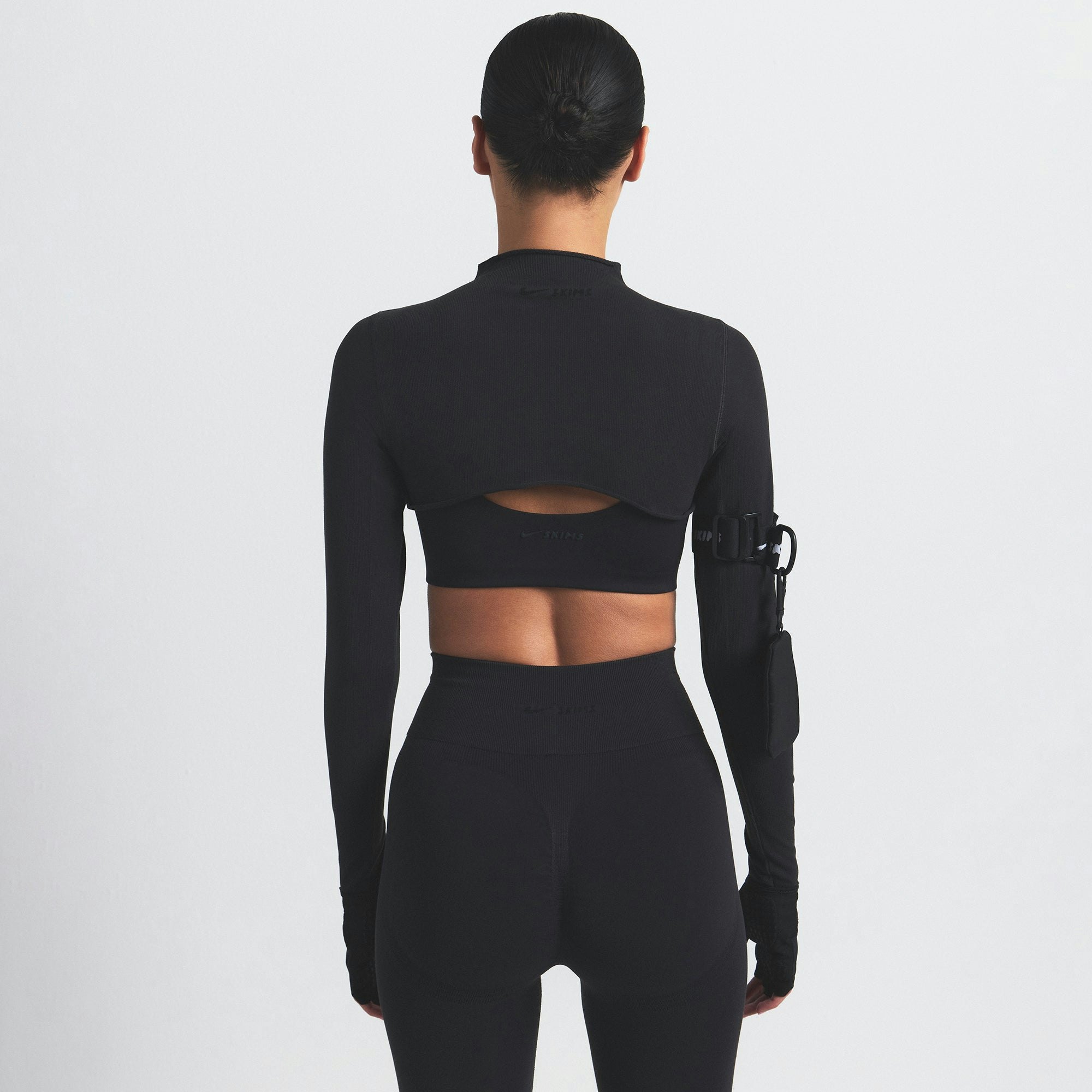 NikeSKIMS VINTAGE SEAMLESS SHRUG | OBSIDIAN ON A MODEL SIDE VIEW