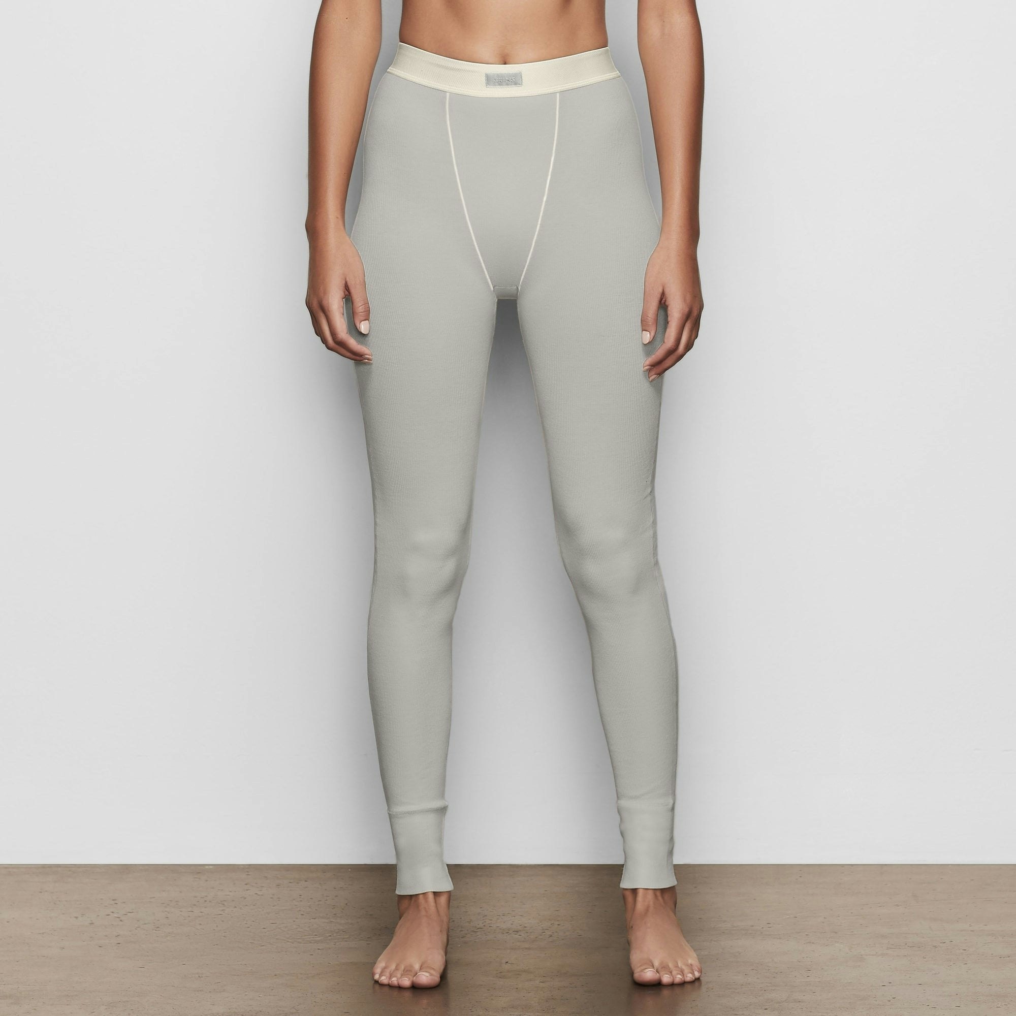 COTTON RIB LEGGING IS SHOWN ON A MODEL POSING IN STYLISTIC CAMPAIGN IMAGERY