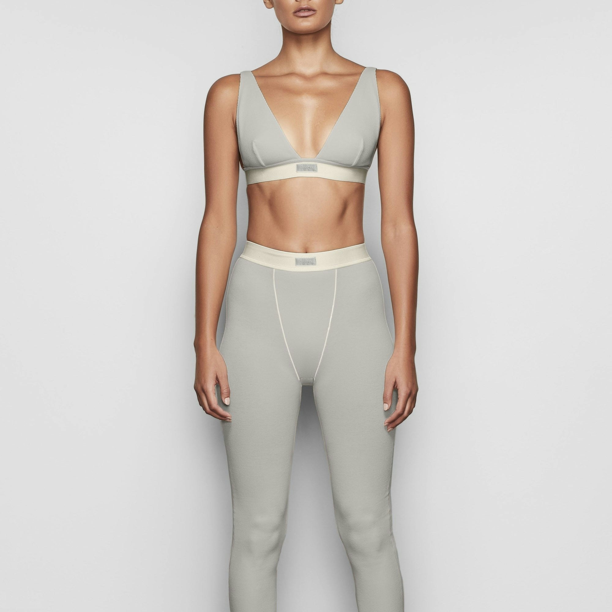 A MODEL STANDS FACING FORWARD WEARING THE COTTON RIB LEGGING | MINERAL
