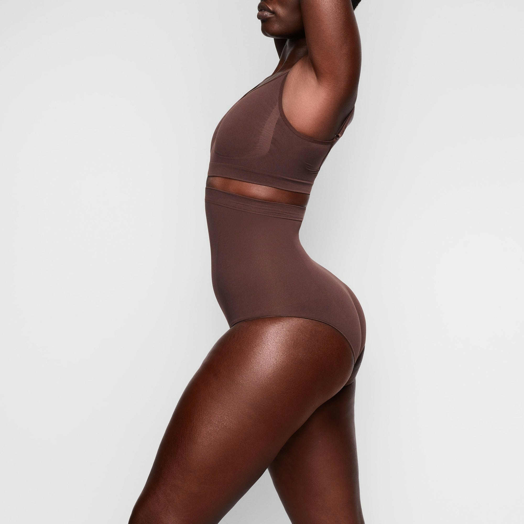 SEAMLESS SCULPT HIGH-WAISTED BRIEF WORN BY A MODEL IN SIDE VIEW