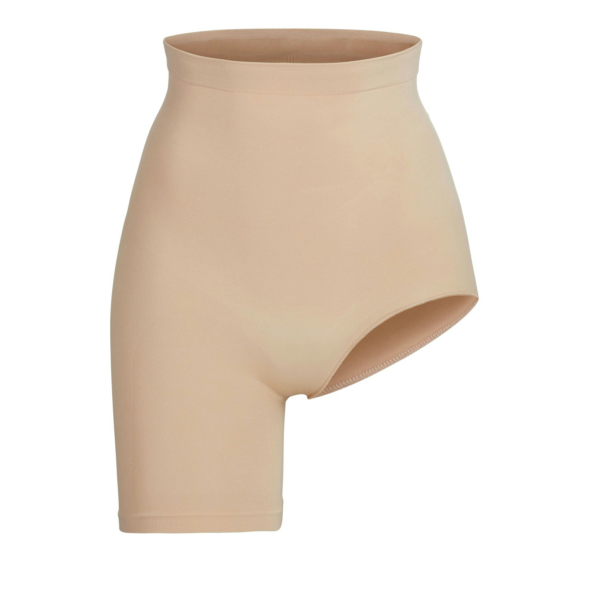 SEAMLESS SCULPT SOLUTION SHORT LEFT LEG EXPOSED | CLAY (SHAPEWEAR SHORTS, BODYSUITS) LAYS FLAT ON A WHITE BACKGROUND | FLT