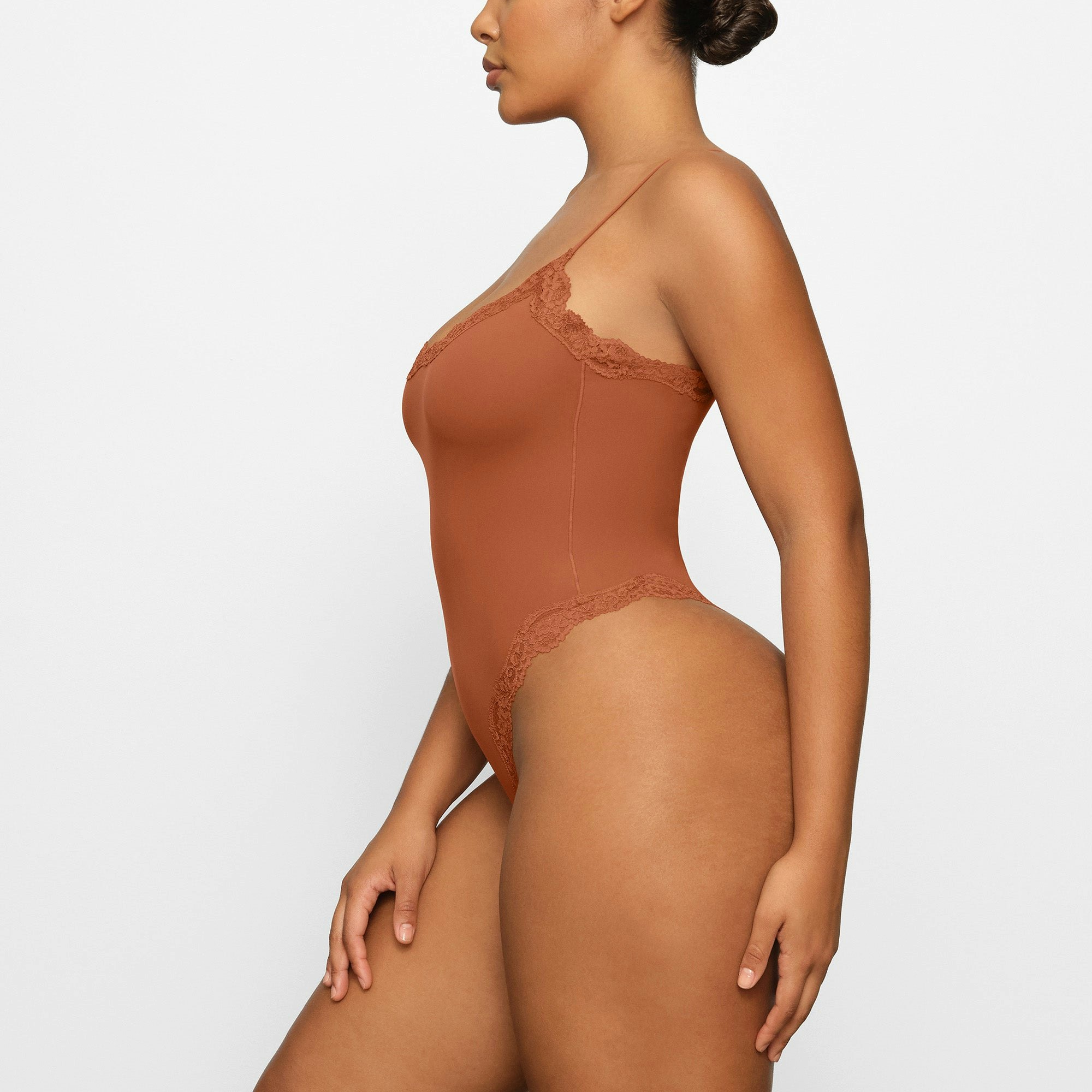 FITS EVERYBODY LACE CAMI BODYSUIT WORN BY A MODEL IN SIDE VIEW